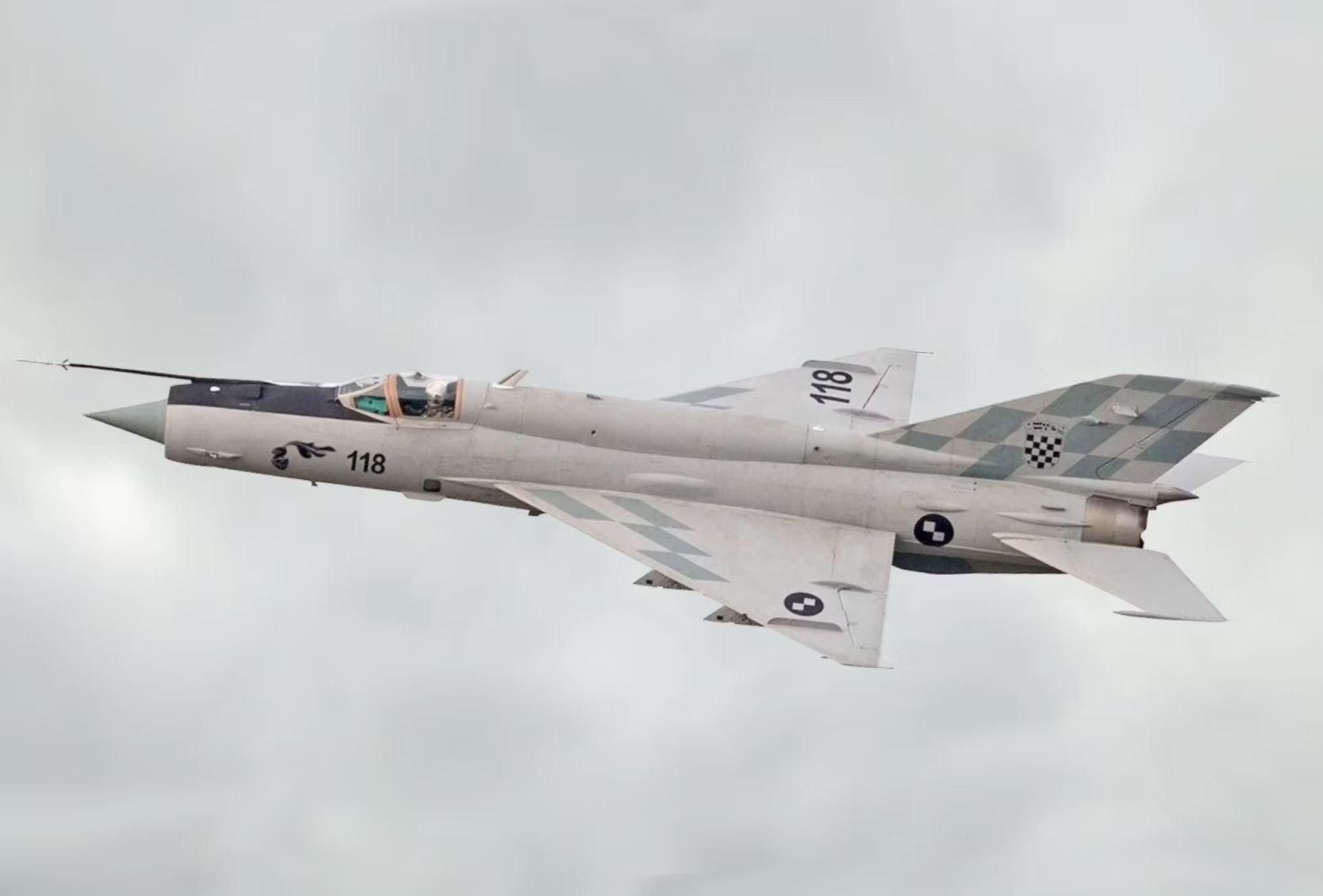 A MiG-21 flying in the sky.