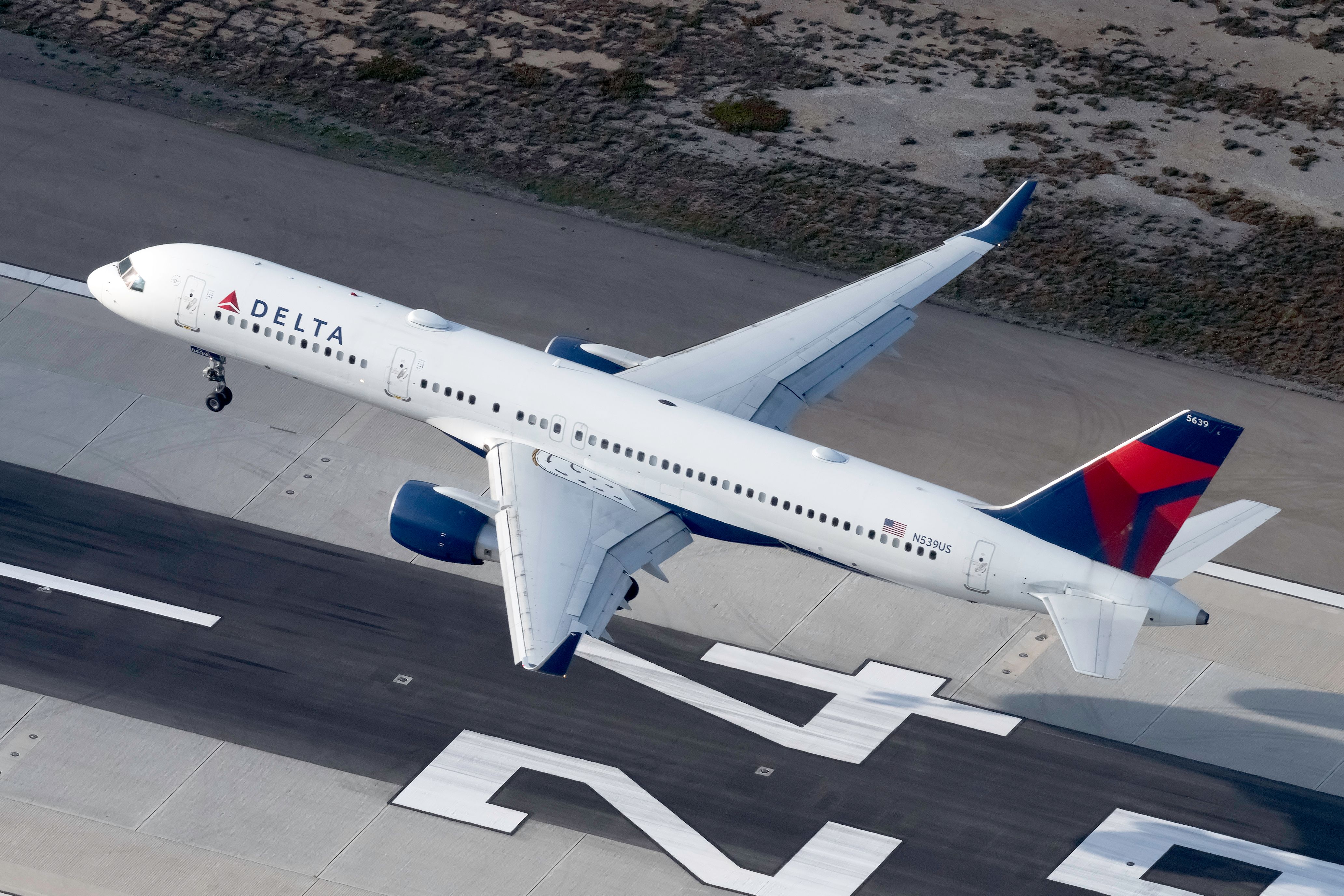 A Delta Air Lines Boeing 757-200 About to land on a runway.