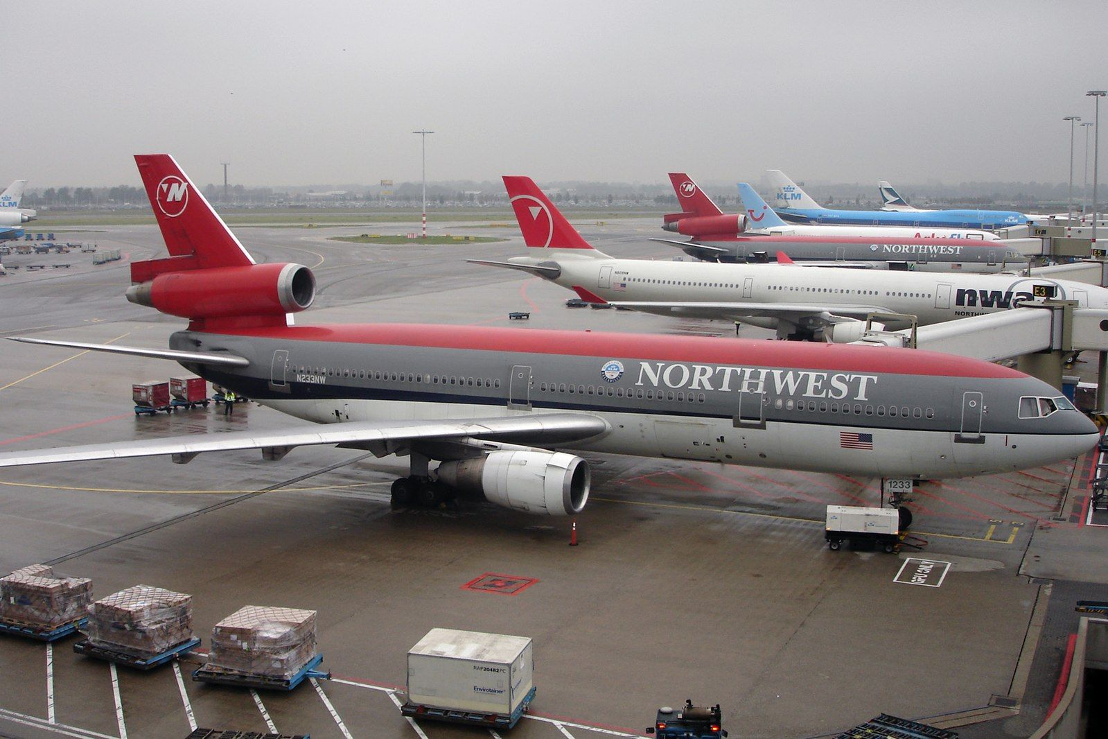 Several Northwest Airlines aircraft parekd on an airport apron.