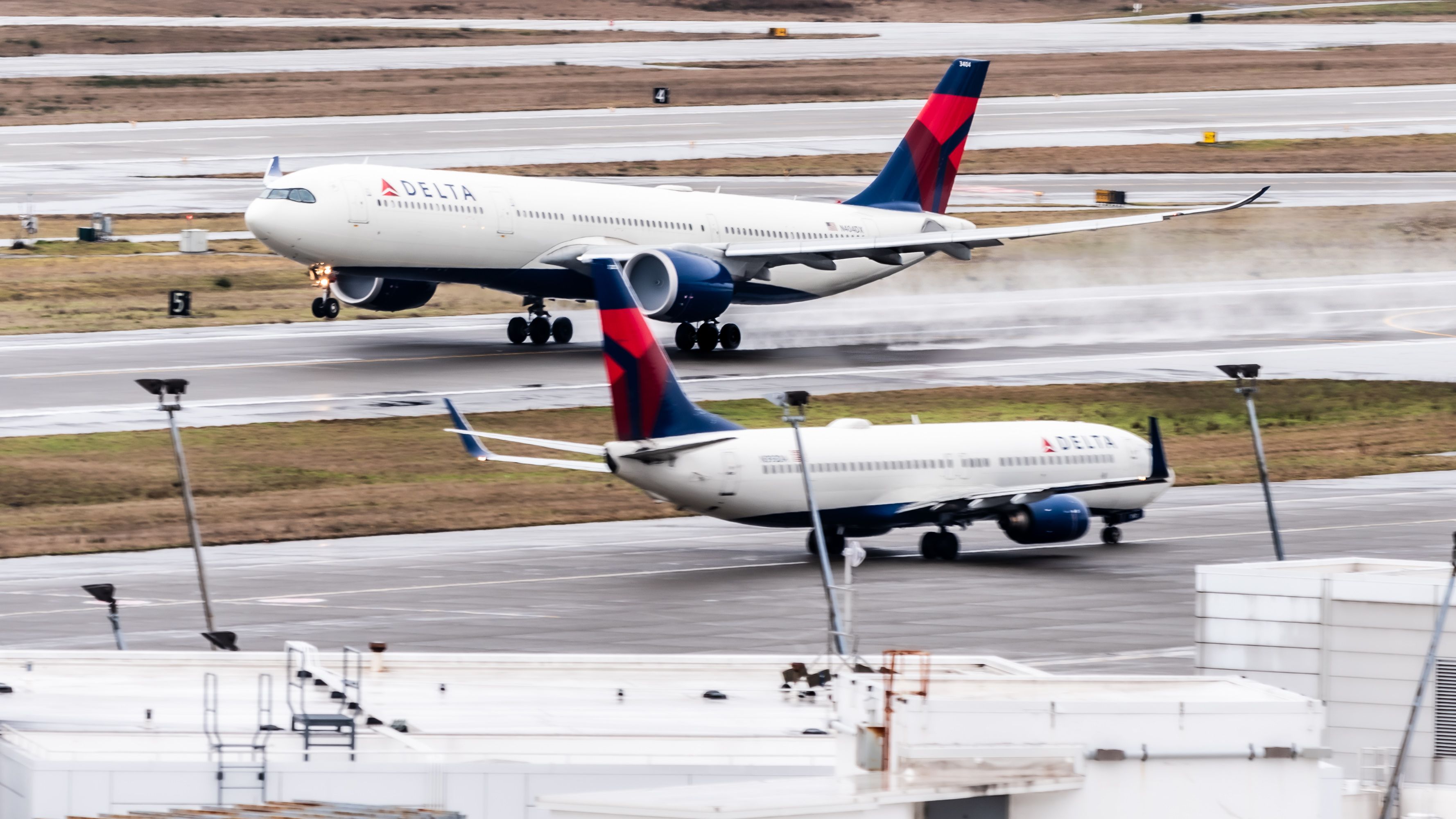 Delta Air Lines Airbus A330-900neo Lifting Off From SEA Past Delta Air Lines Boeing 737 - 16x9