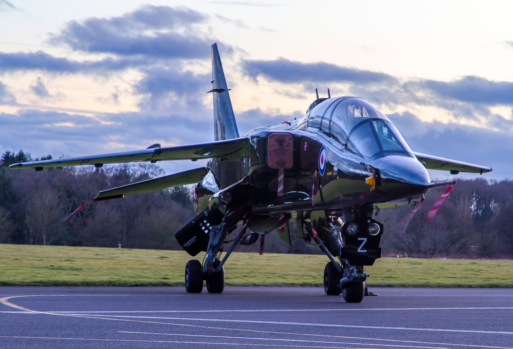 An RAF SEPECAT Jaguar parked on an airfield apron.