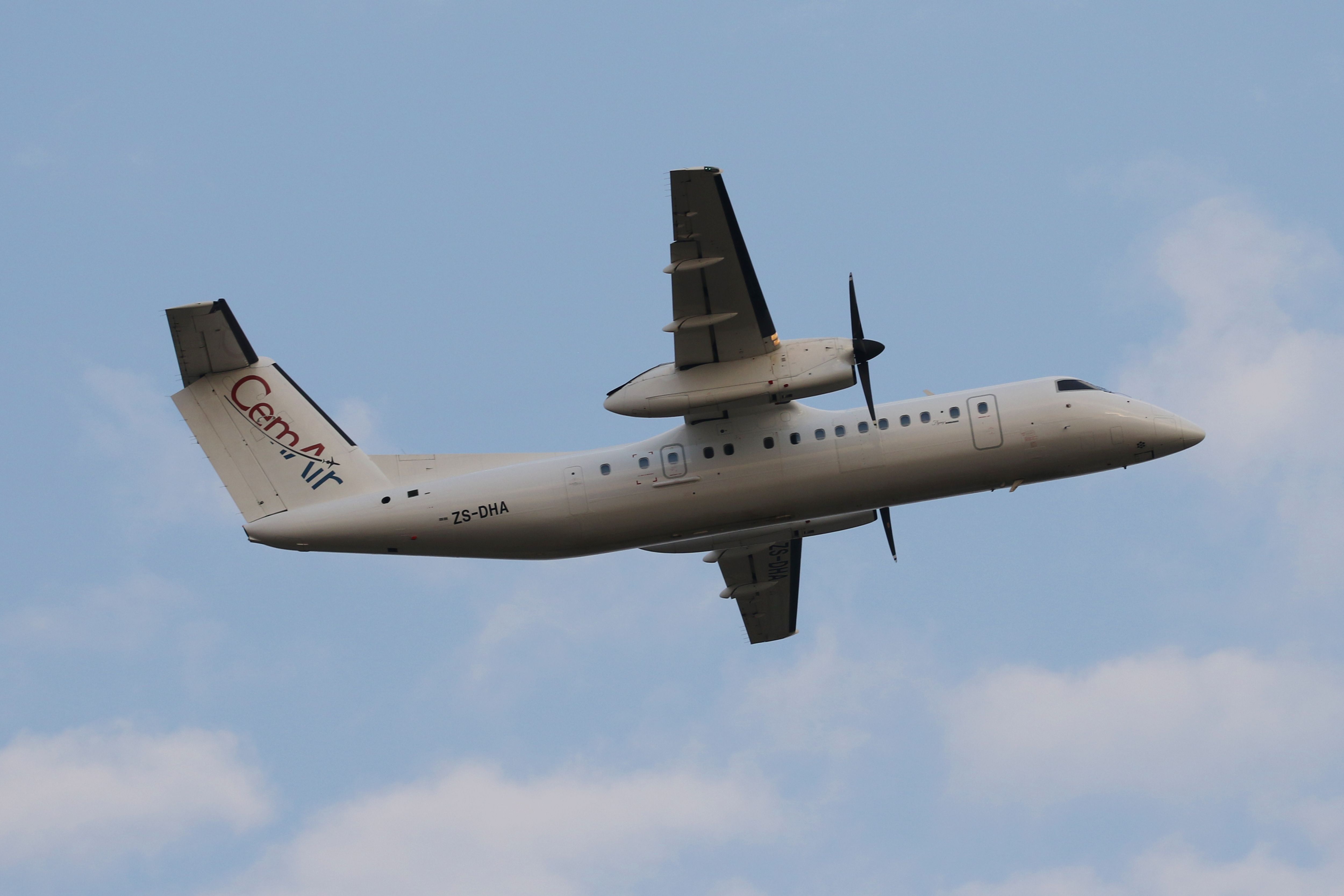 A CemAir DHC Dash 8 flying in the sky.