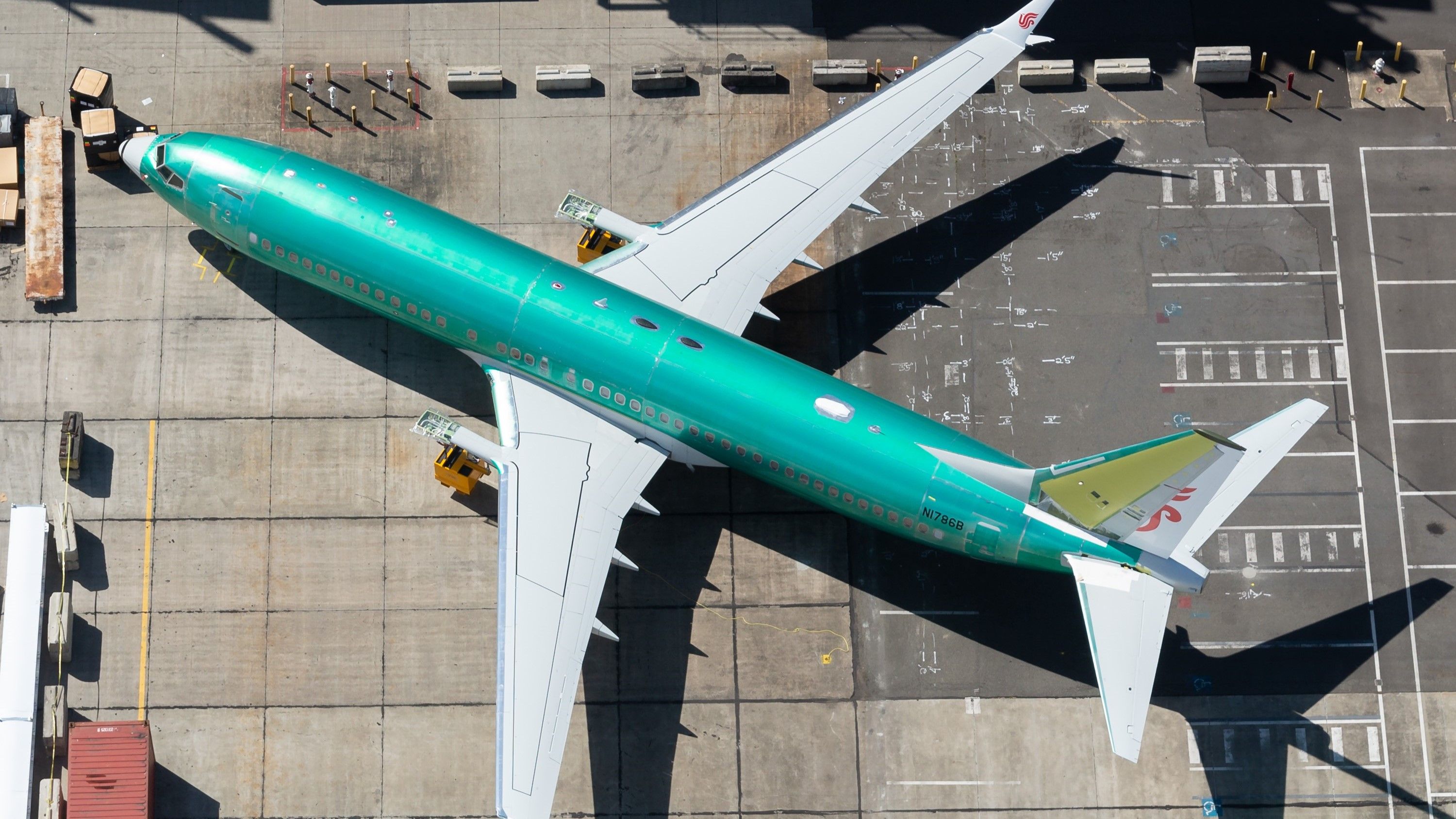 Boeing 737 MAX wearing protective green coat close to Boeing Factory at Renton Field. Aircraft tail showing Air China paint scheme.