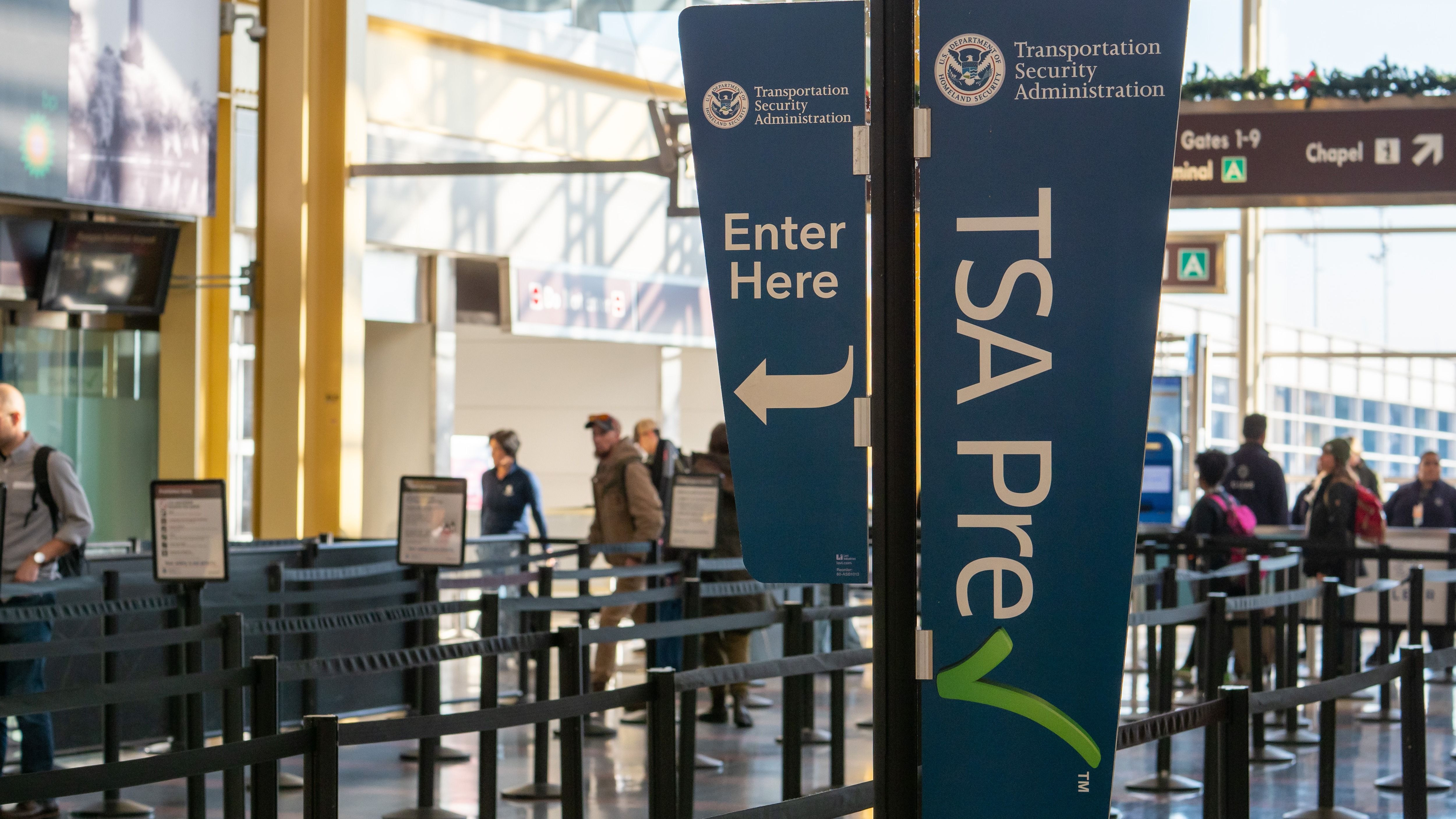 A TSA Precheck sign before security at Reagan National Airport.