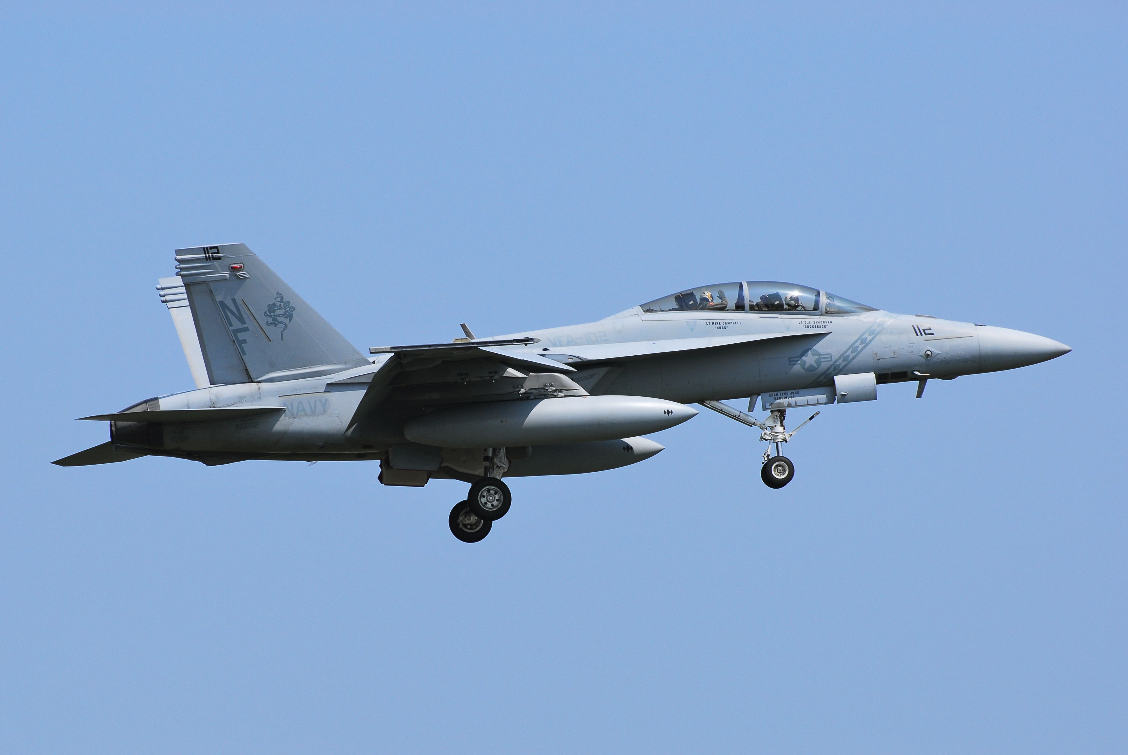 A United States Navy Boeing F/A-18F Super Hornet flying in the sky.
