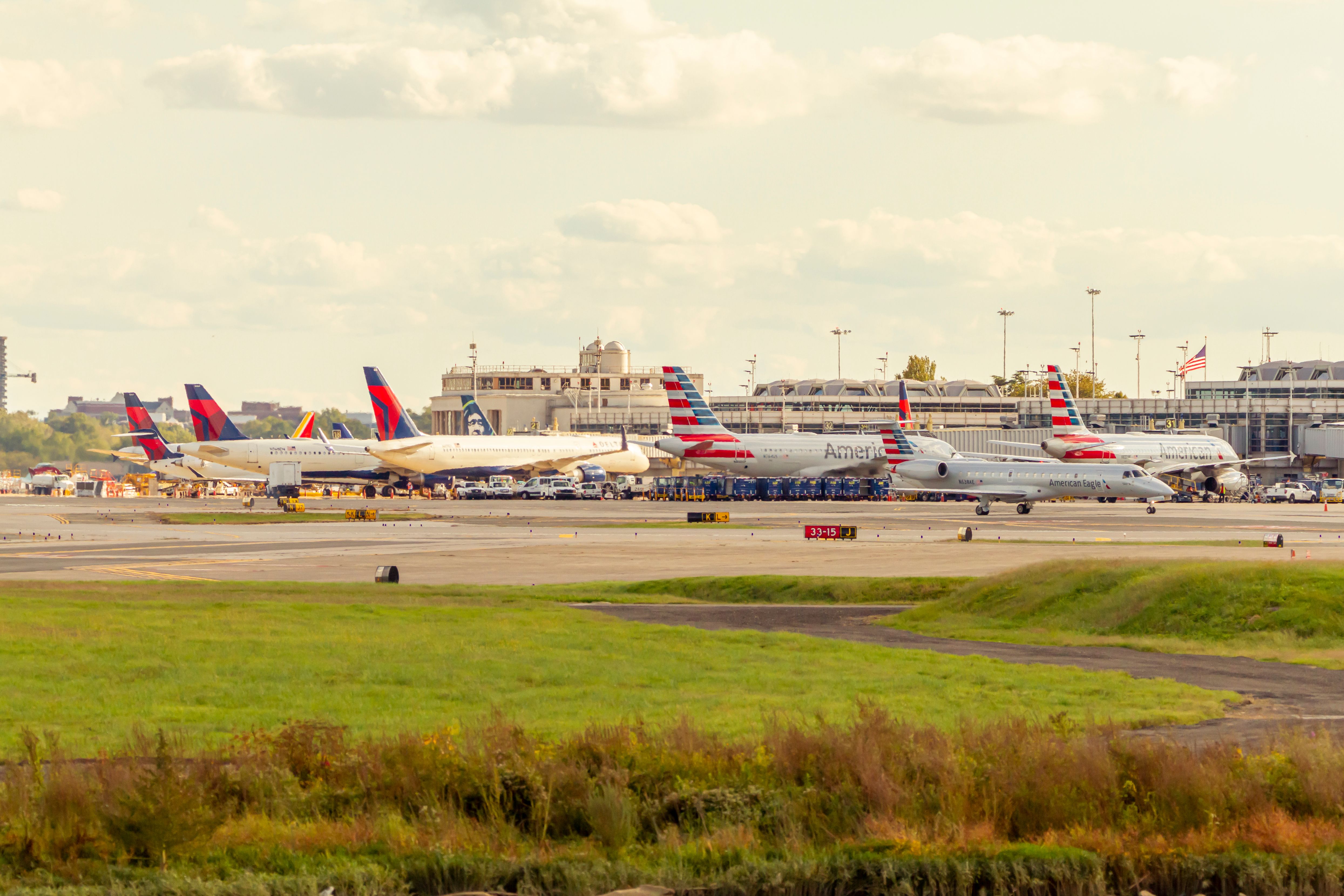 Image of planes from different airlines waiting at gates for loading and unloading in front of terminal building of Reagan National Airport. 