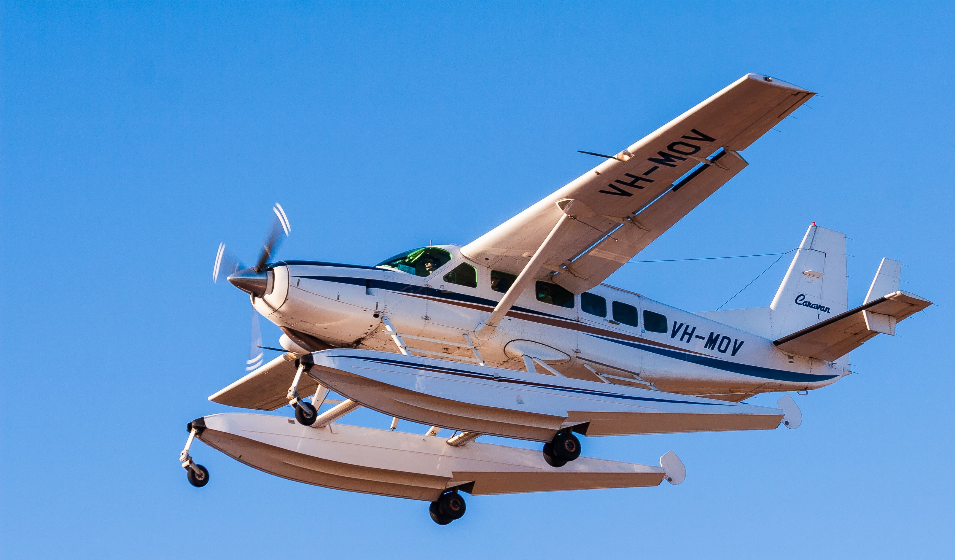 A Cessna 208 Caravan flying in the sky.