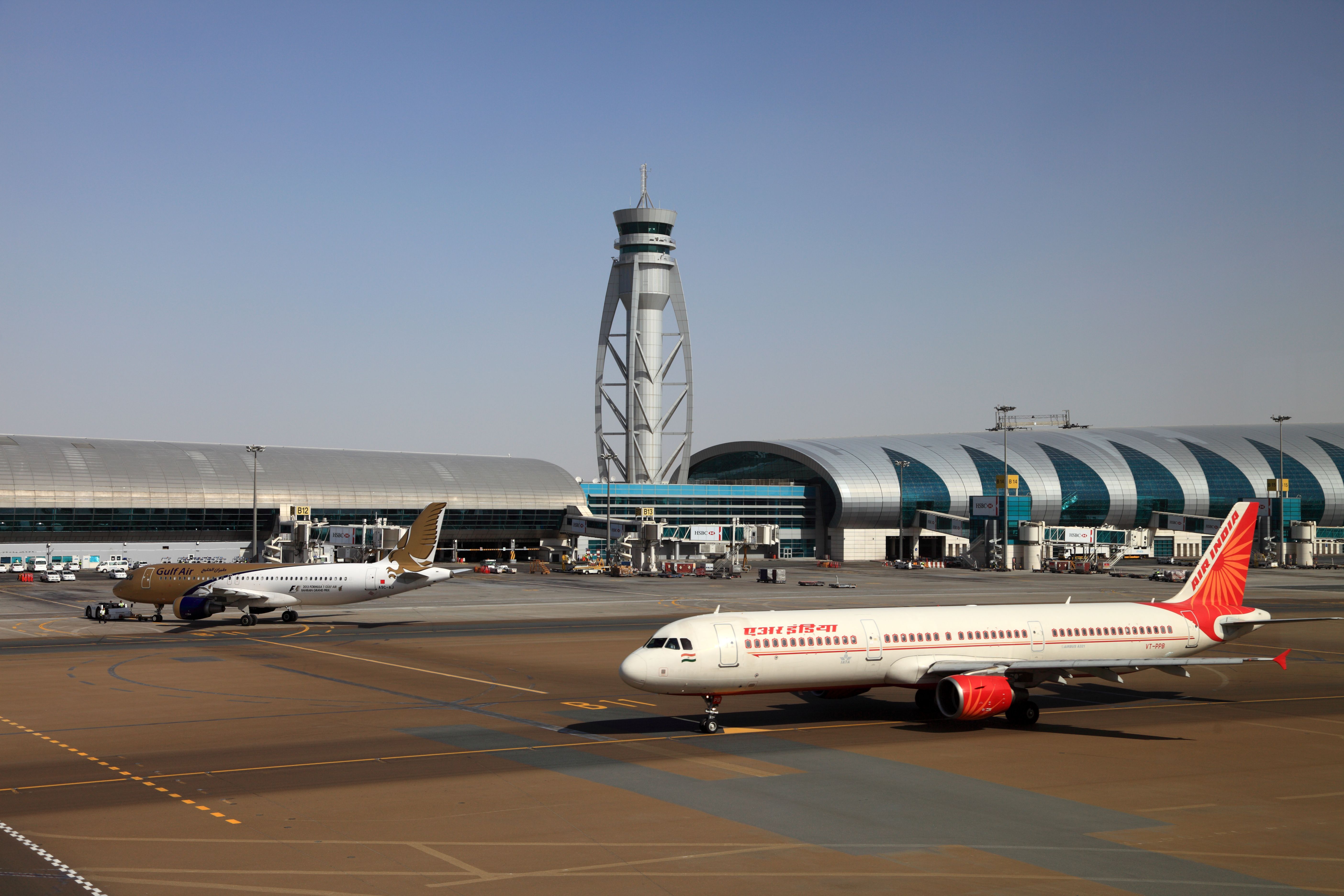 An Air India Airbus A321 and Gulf Air A320 on the apron At Dubai International Airport.