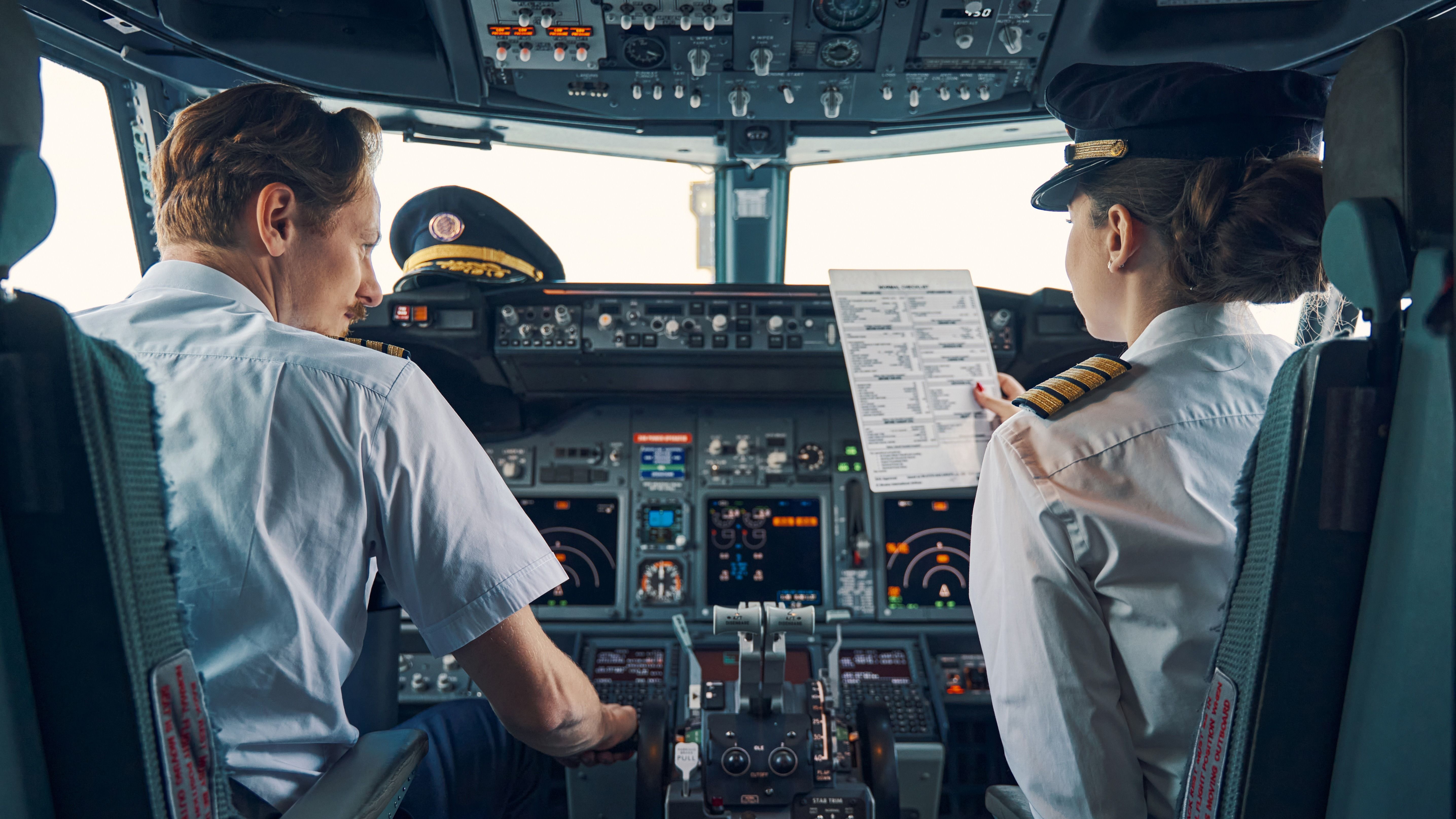 Two Pilots sitting in a cockpit.