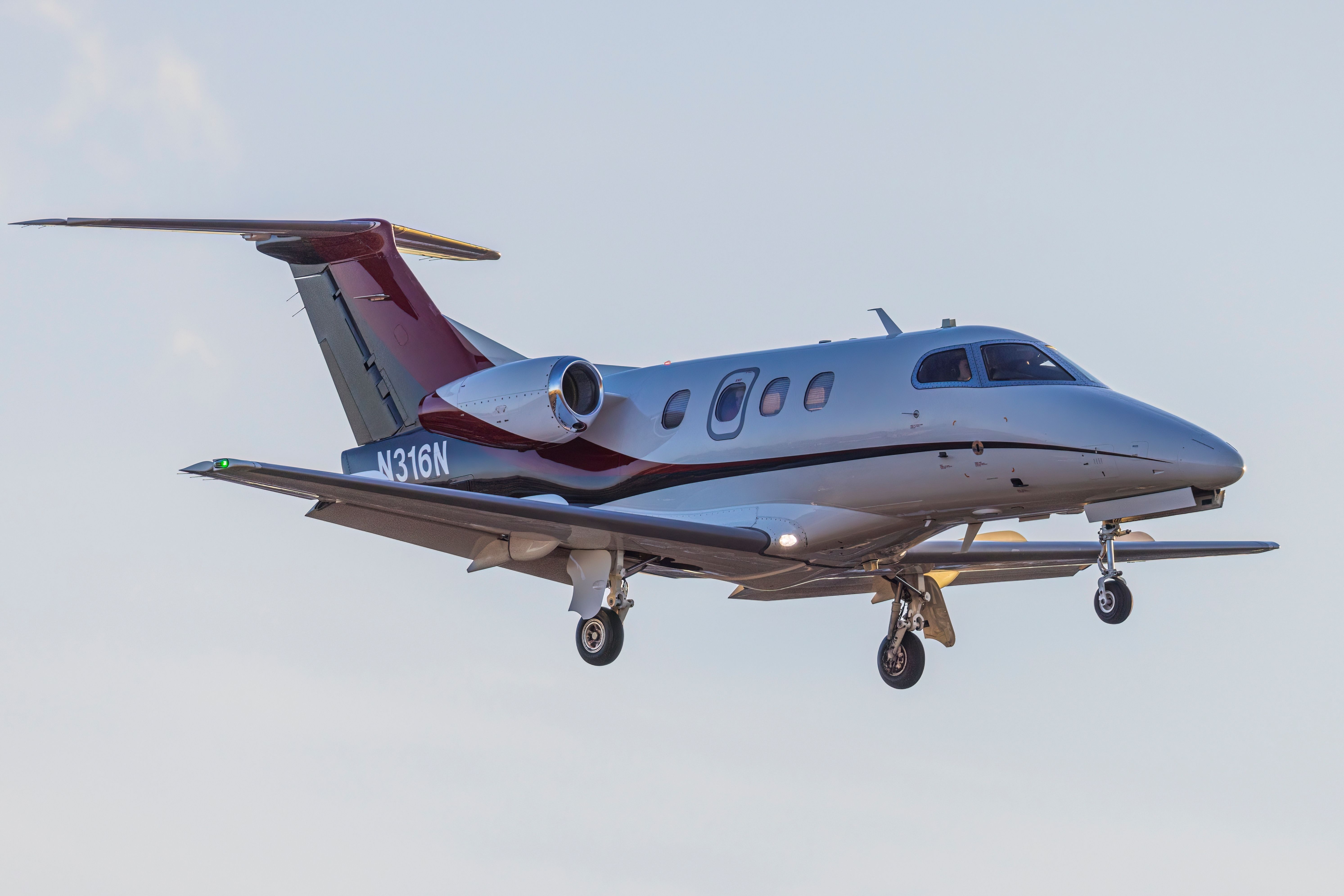 An Embraer Phenom EMB-500 arrives at the Centennial Airport at sunset