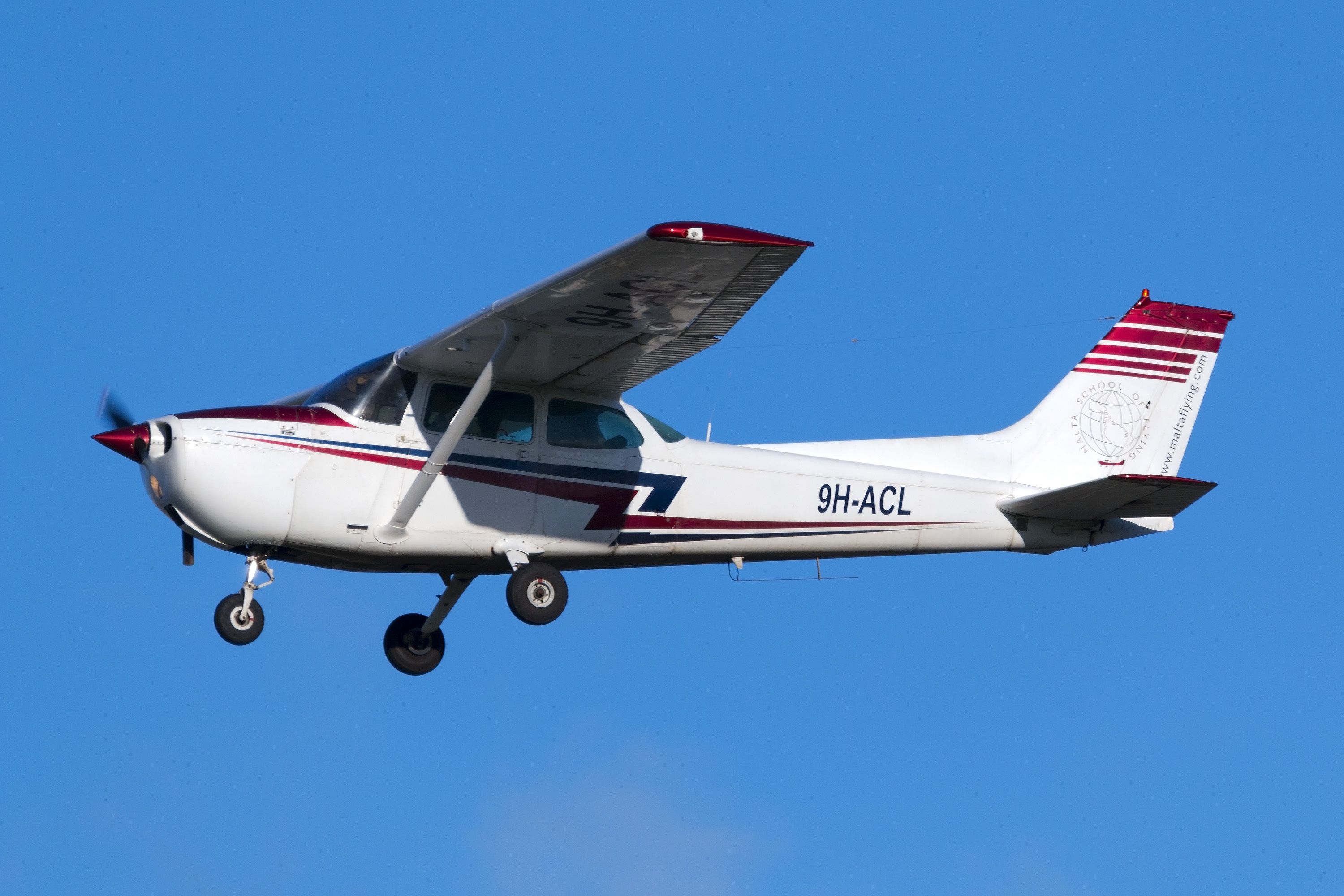 A Cessna 172 flying in the sky.