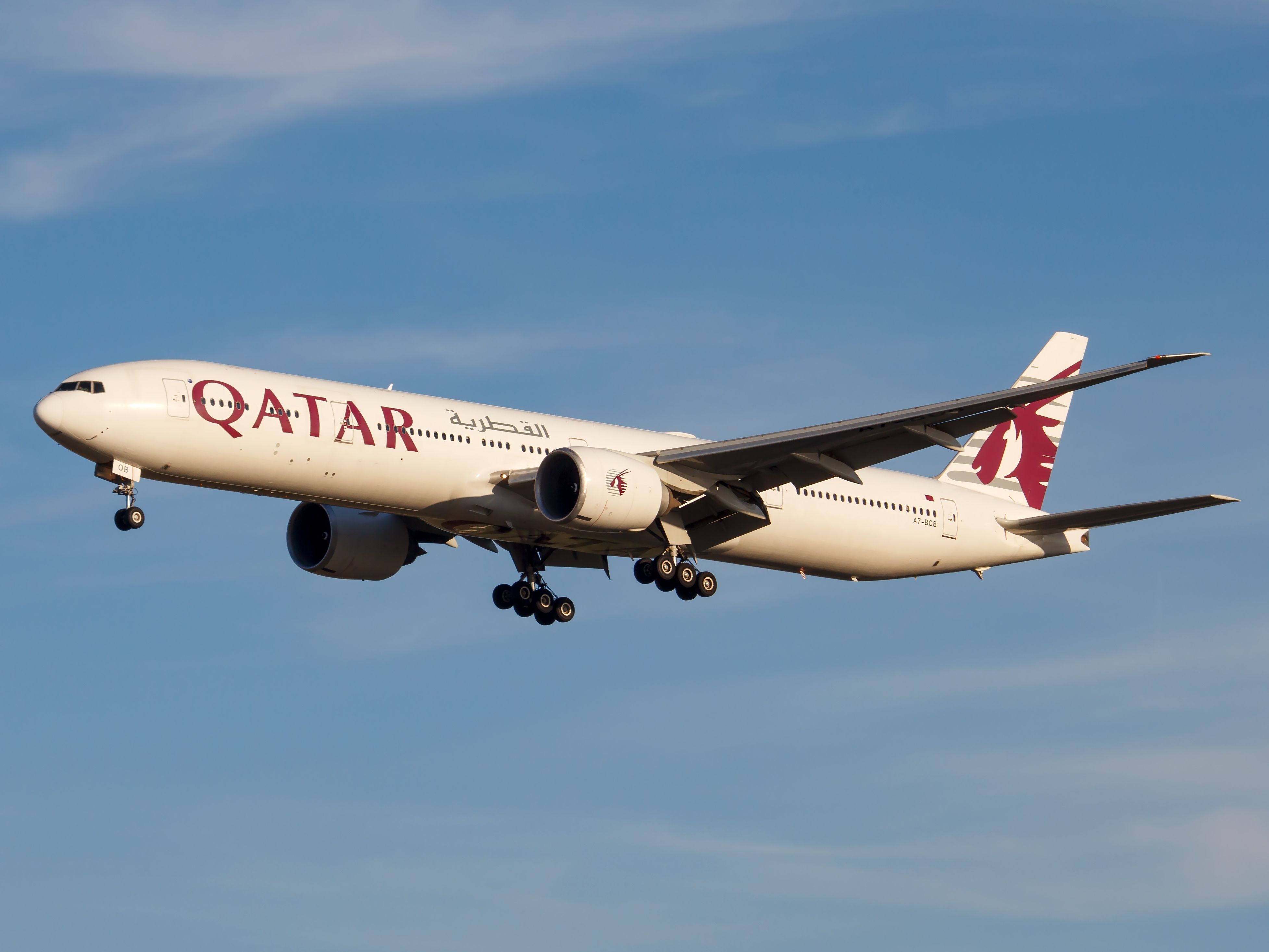 A Qatar Airways Boeing 777-300ER Flying in the sky.