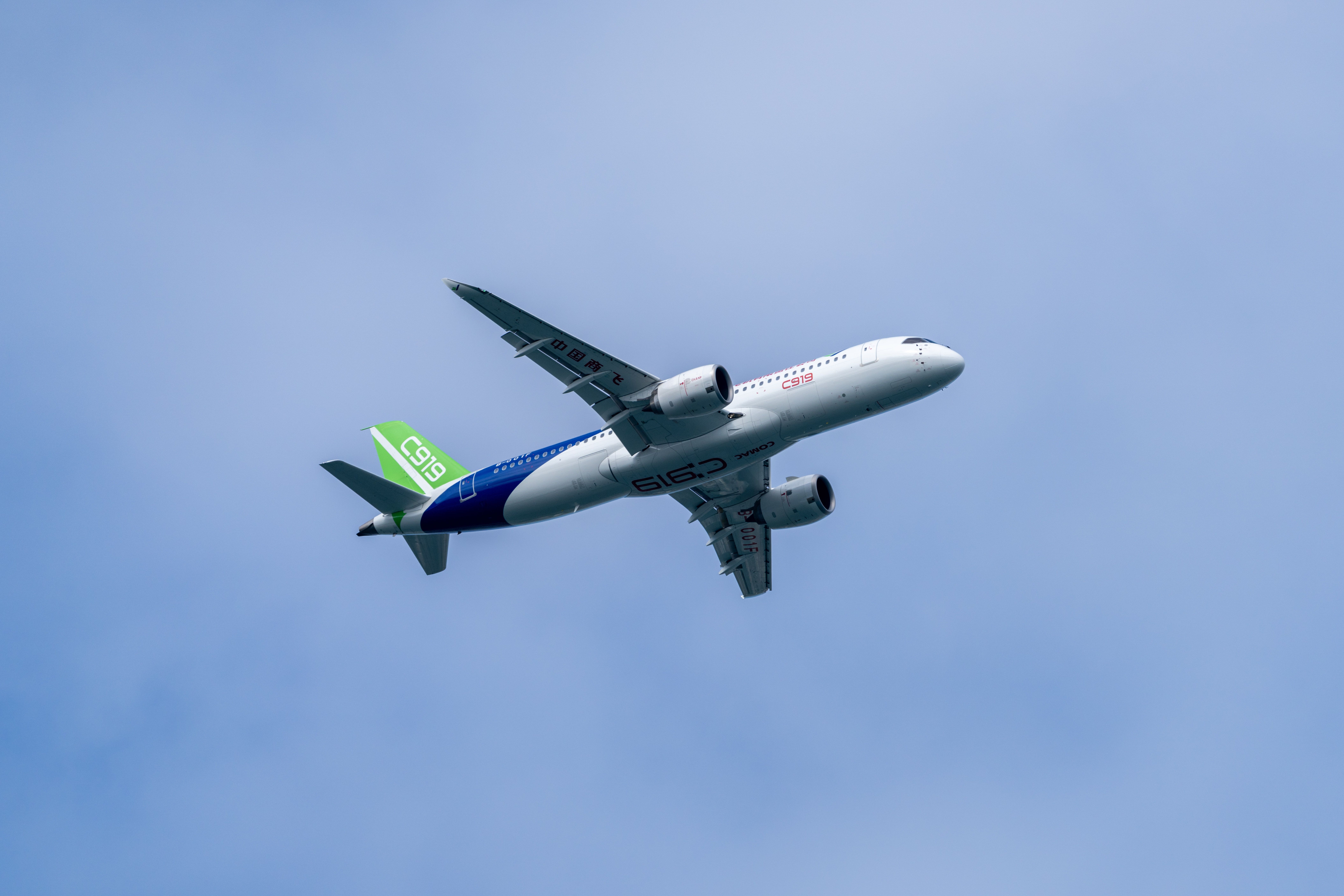 Comac C919 flying over Hong Kong Victoria Harbour. The C919 is a narrow-body airliner developed by Chinese aircraft manufacturer Comac.
