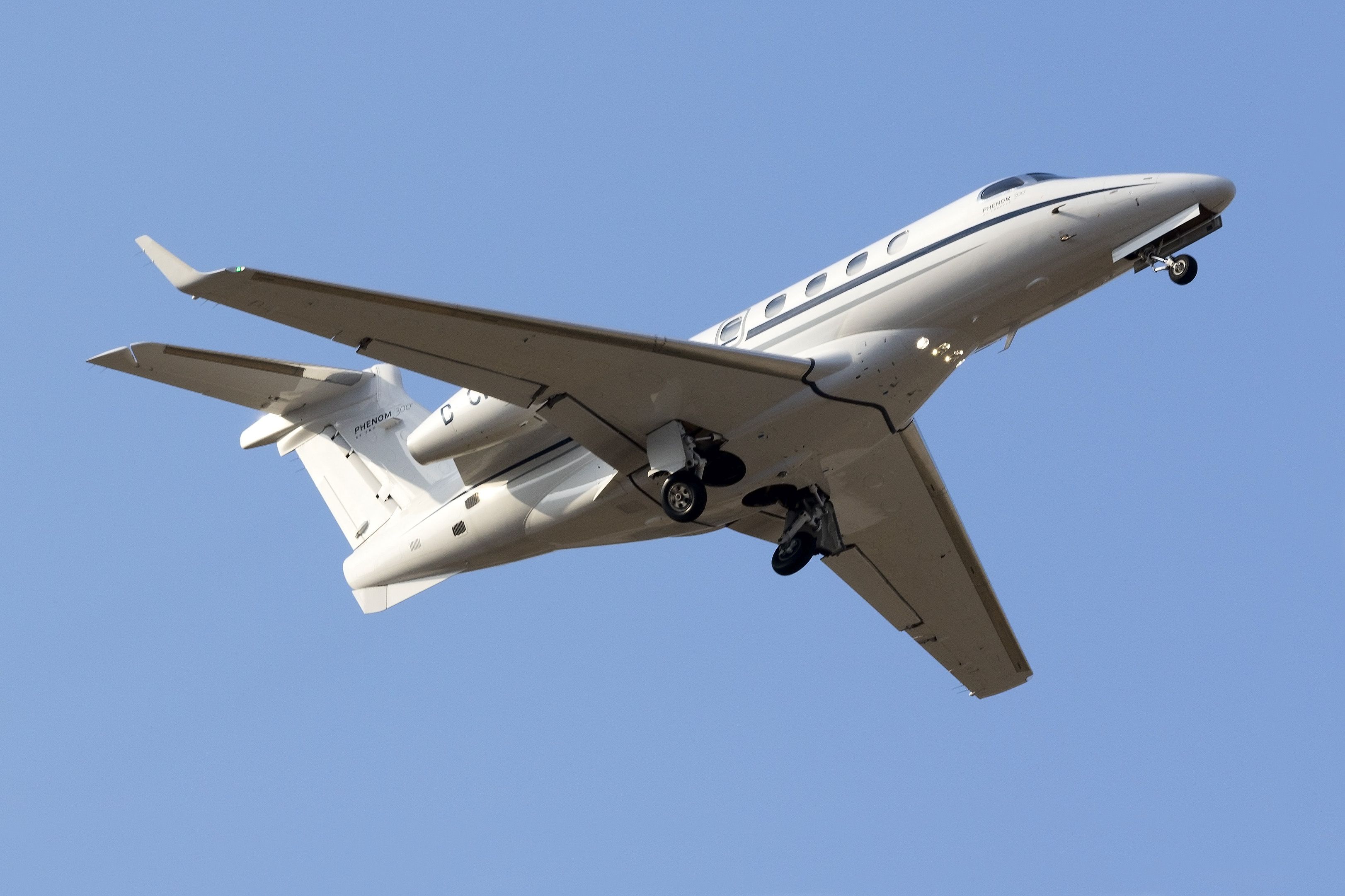 An Embraer EMB-505 Phenom 300 Flying in the sky.
