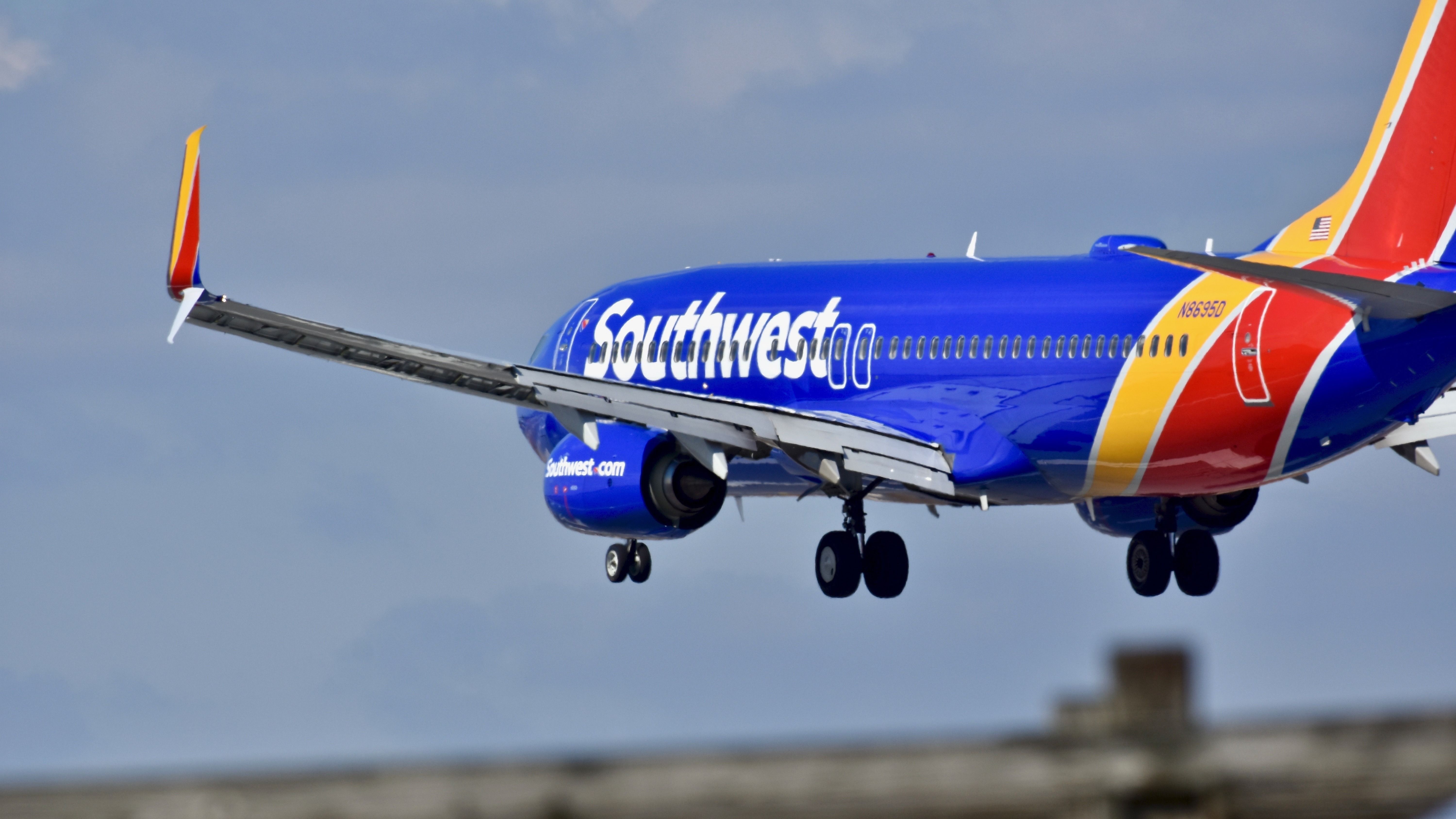 A Southwest Airlines Boeing 737 flying low to the ground.