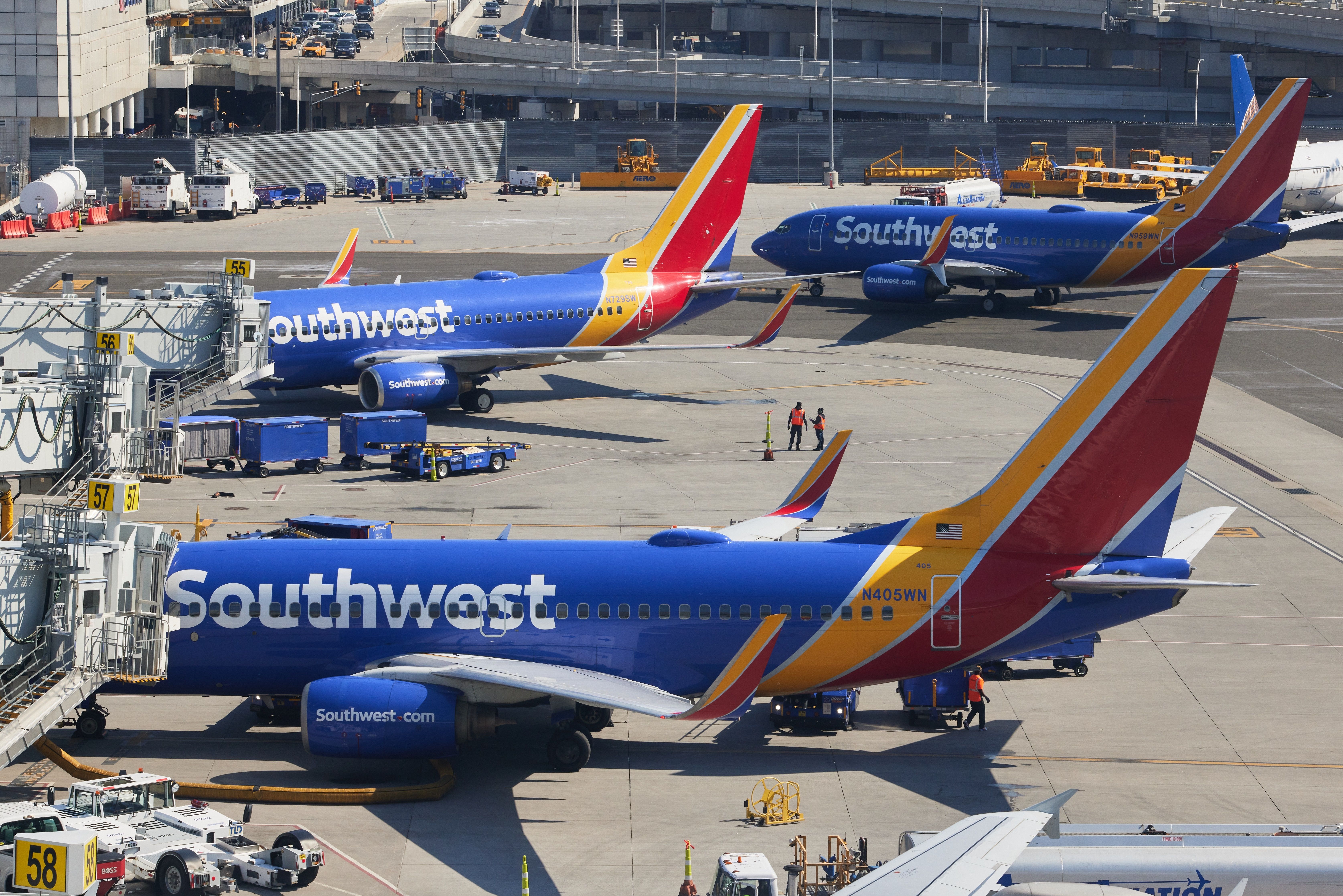 Several Southwest Boeing 737s on an airport apron.