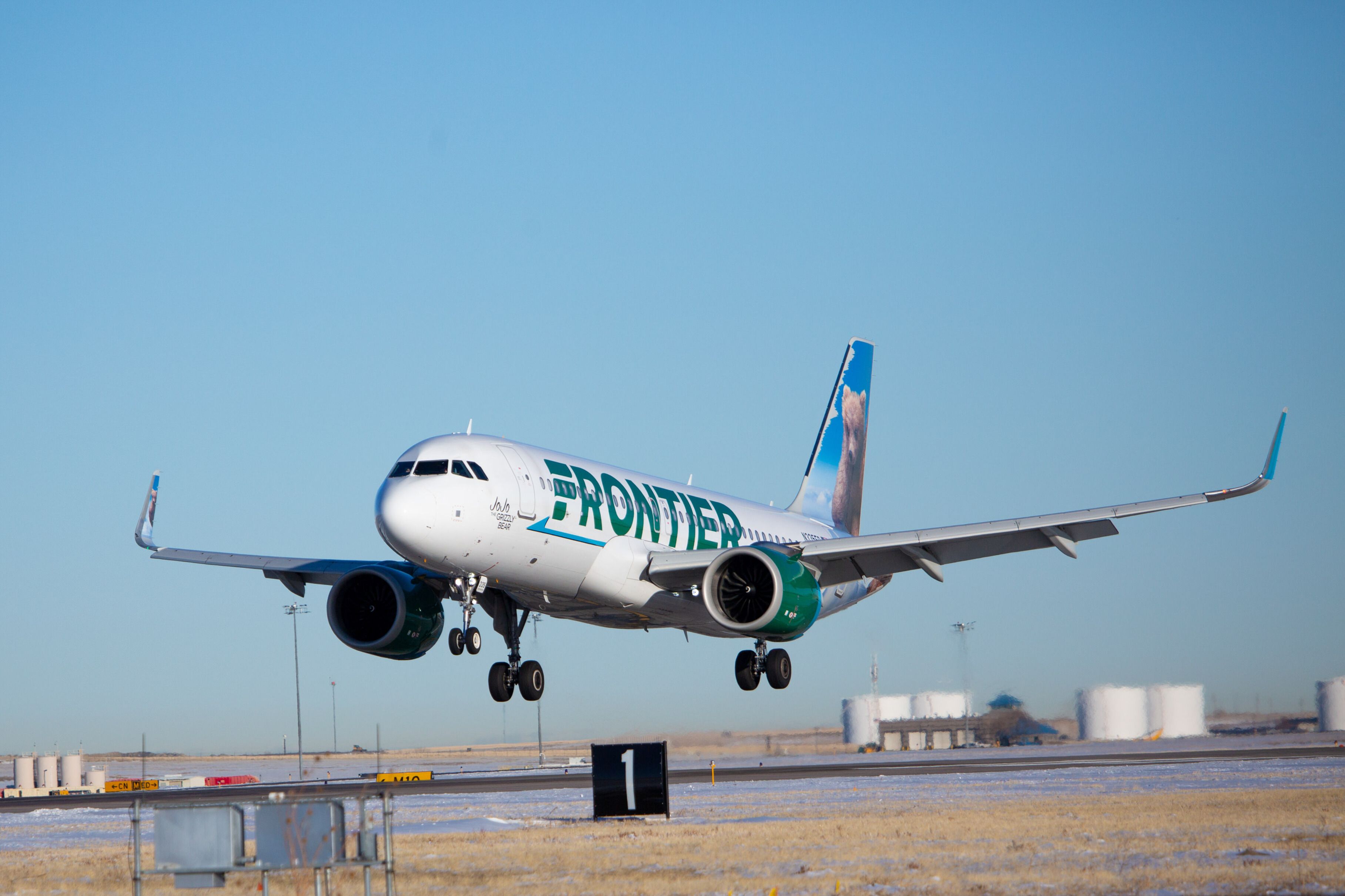 A Frontier Airlines plane about to land.