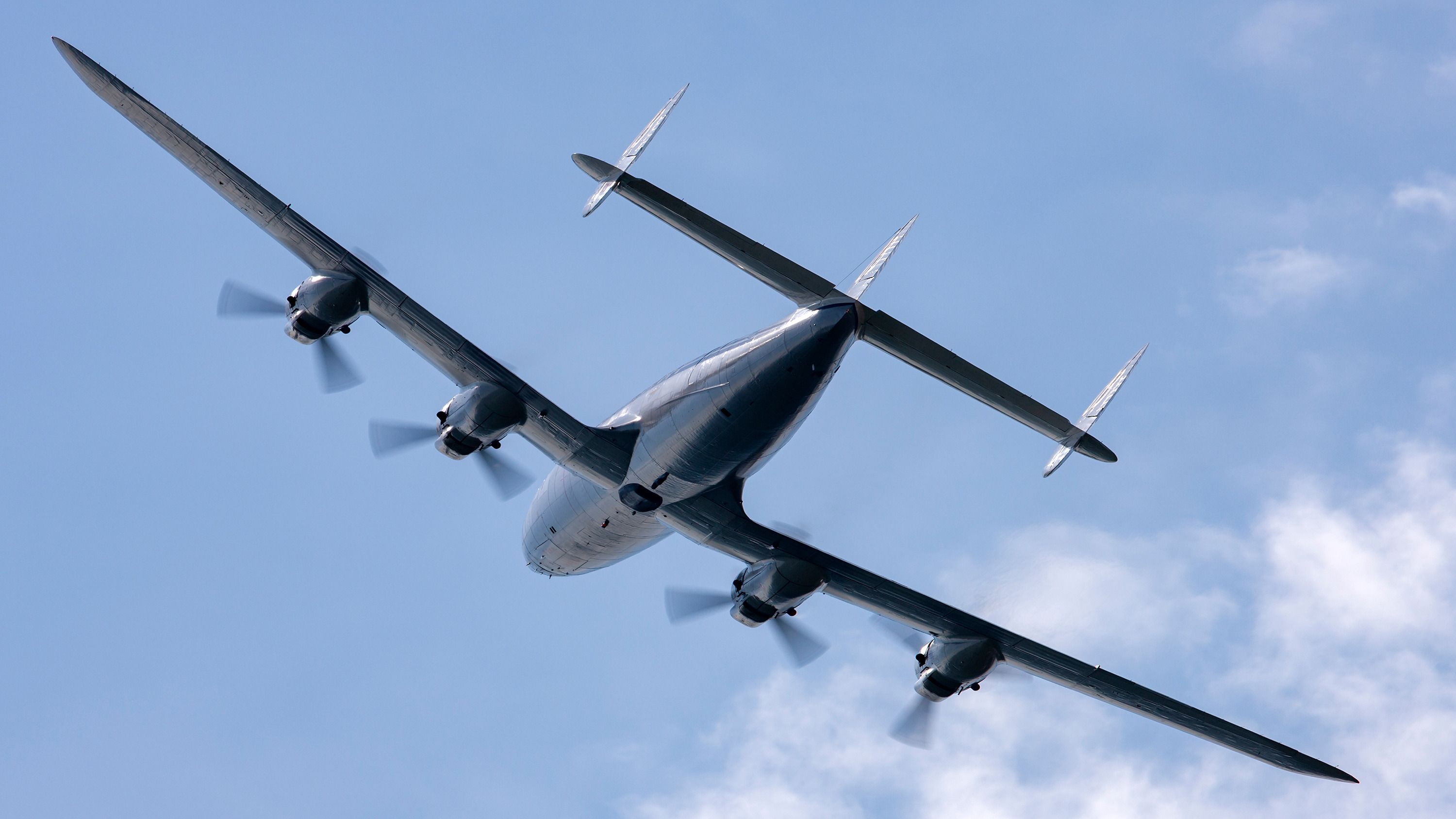 A Lockheed L-1049F Super Constellation flying in the sky.