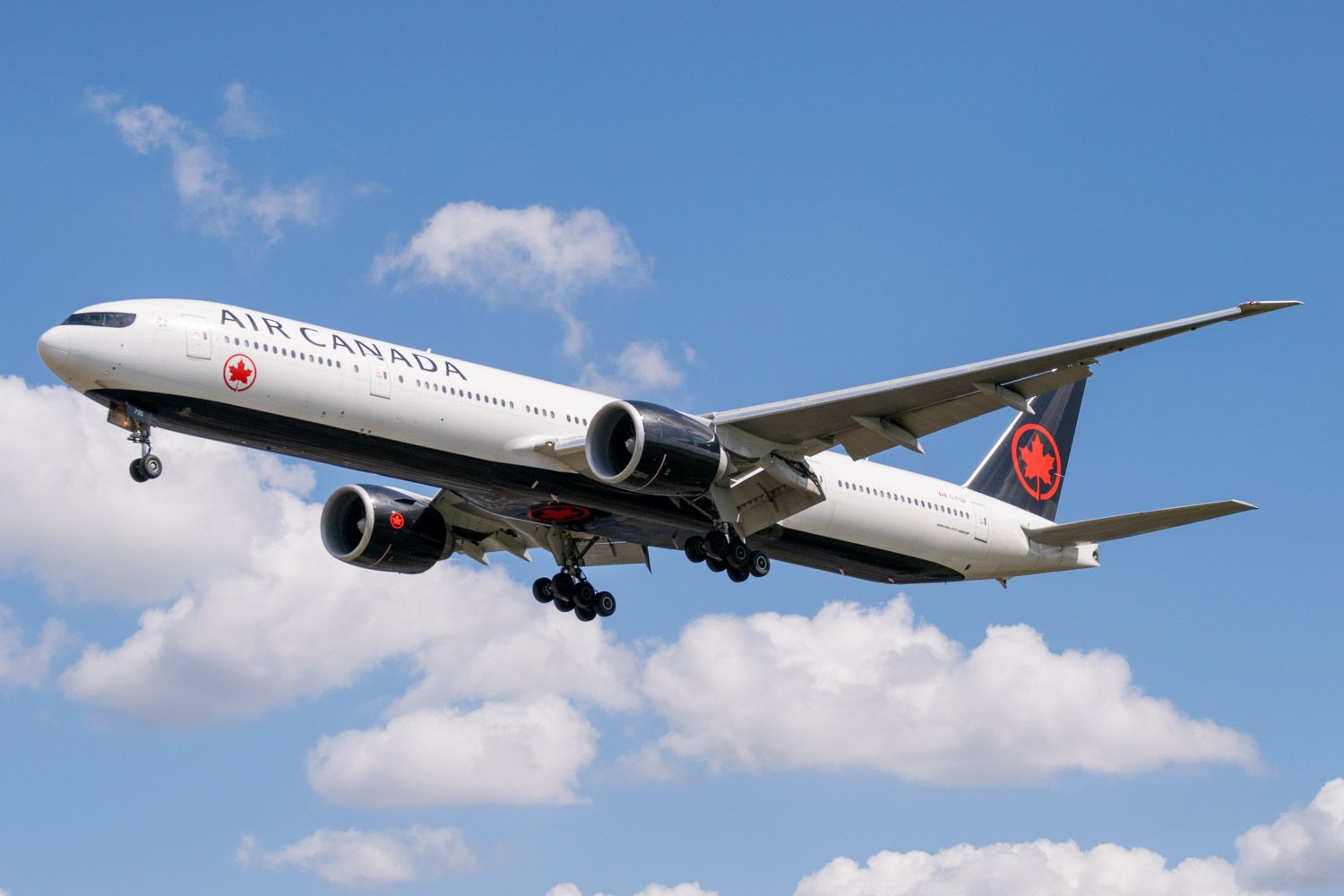 An Air Canada Boeing 777-300ER flying in the sky.