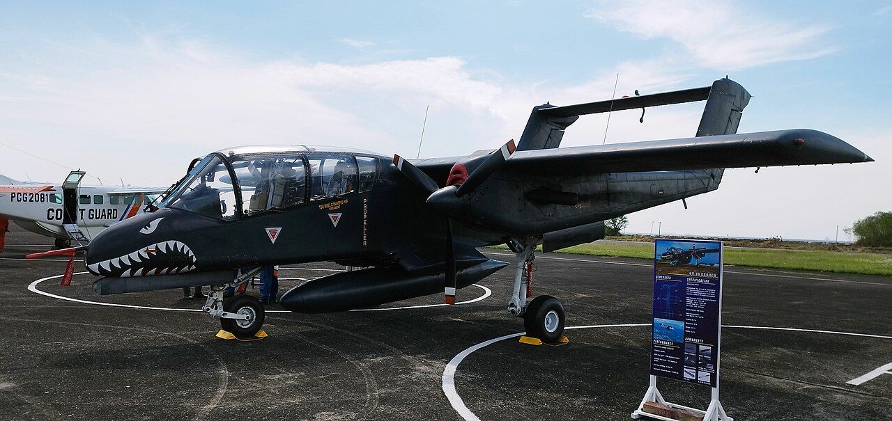 A North American OV-10 Bronco parked on an airport apron.