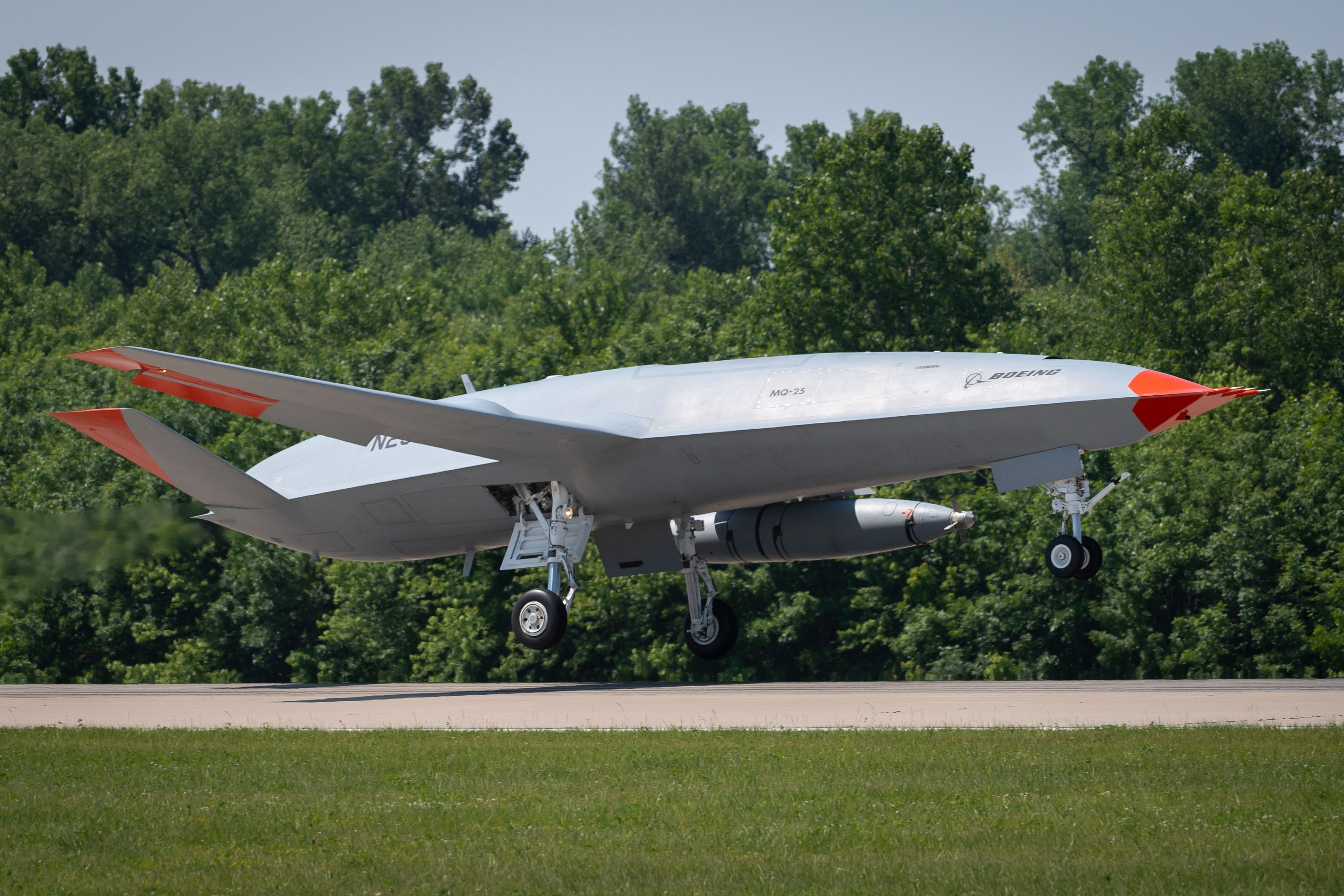 A Boeing MQ-25 Stingray just above a runway.