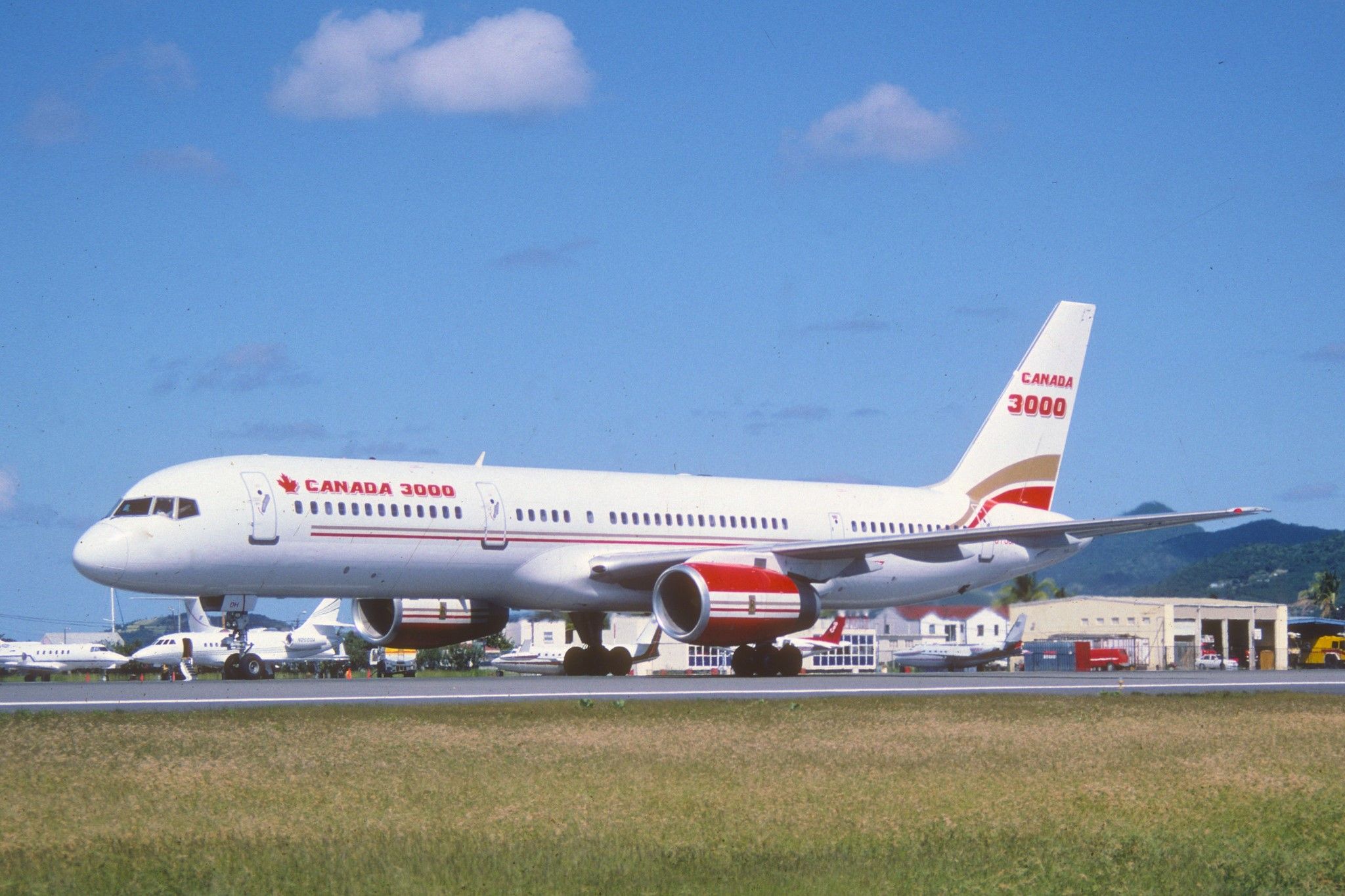 A Canada 3000 Boeing 757 on an airport apron.