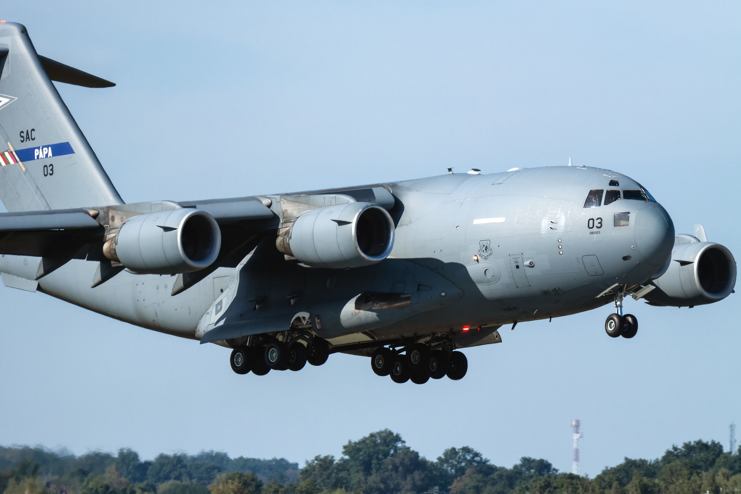 A Boeing C-17 Globemaster III Flying low to the ground.