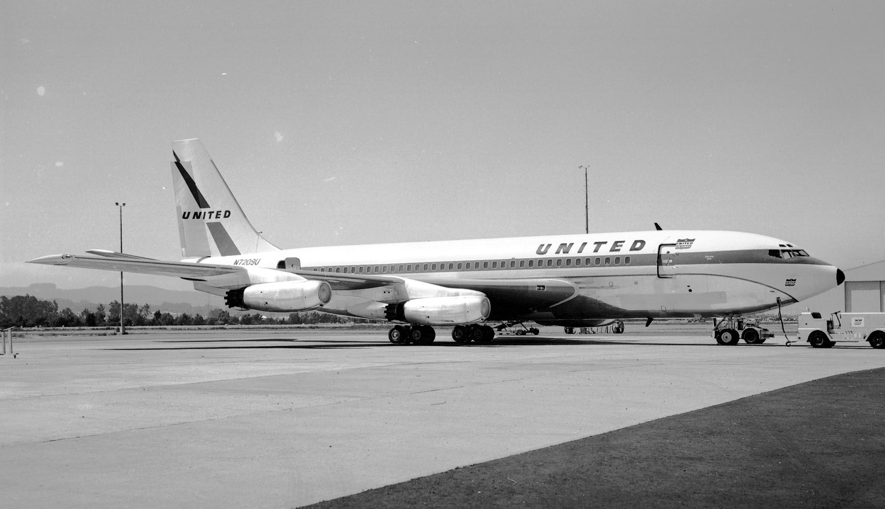 A United Airlines Boeing 720 on an airport apron.