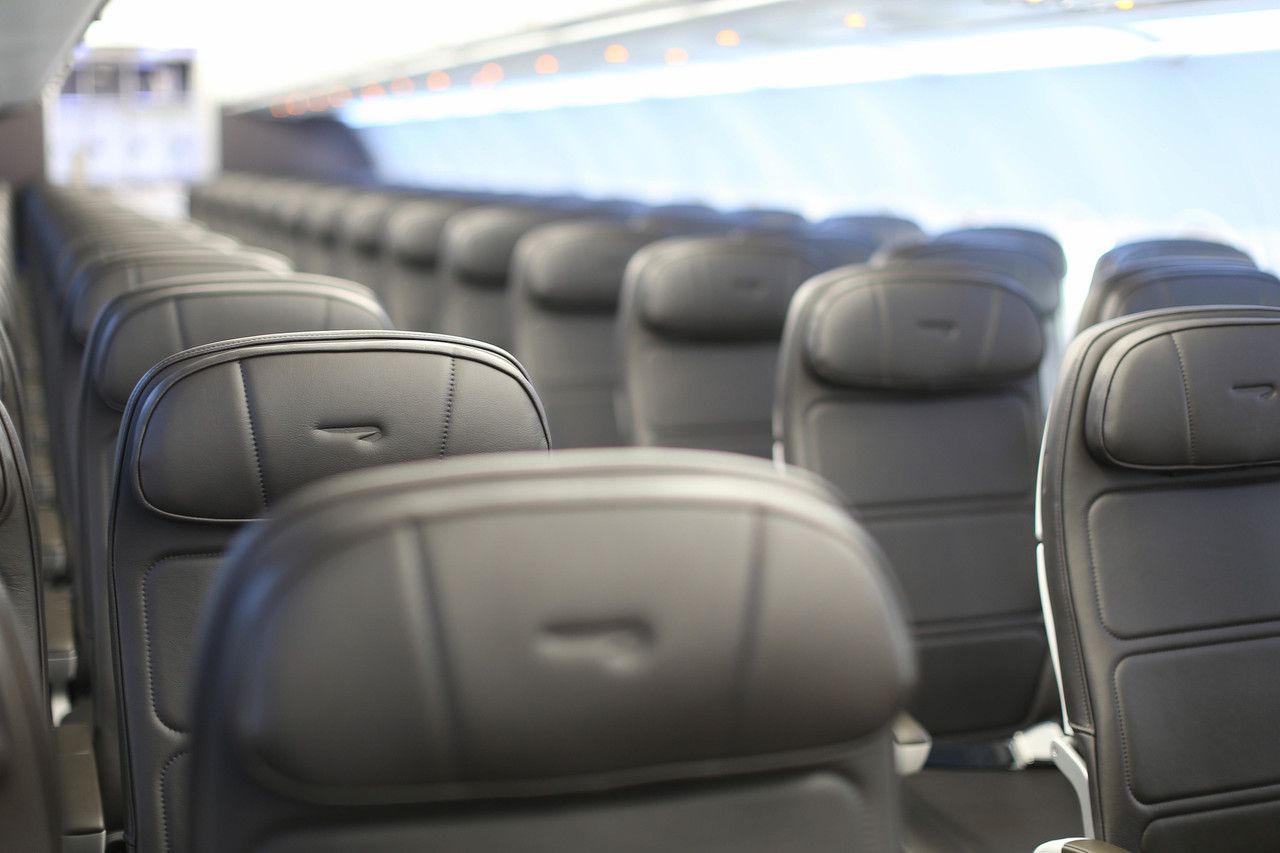 An Empty British Airways narrowbody aircraft cabin.