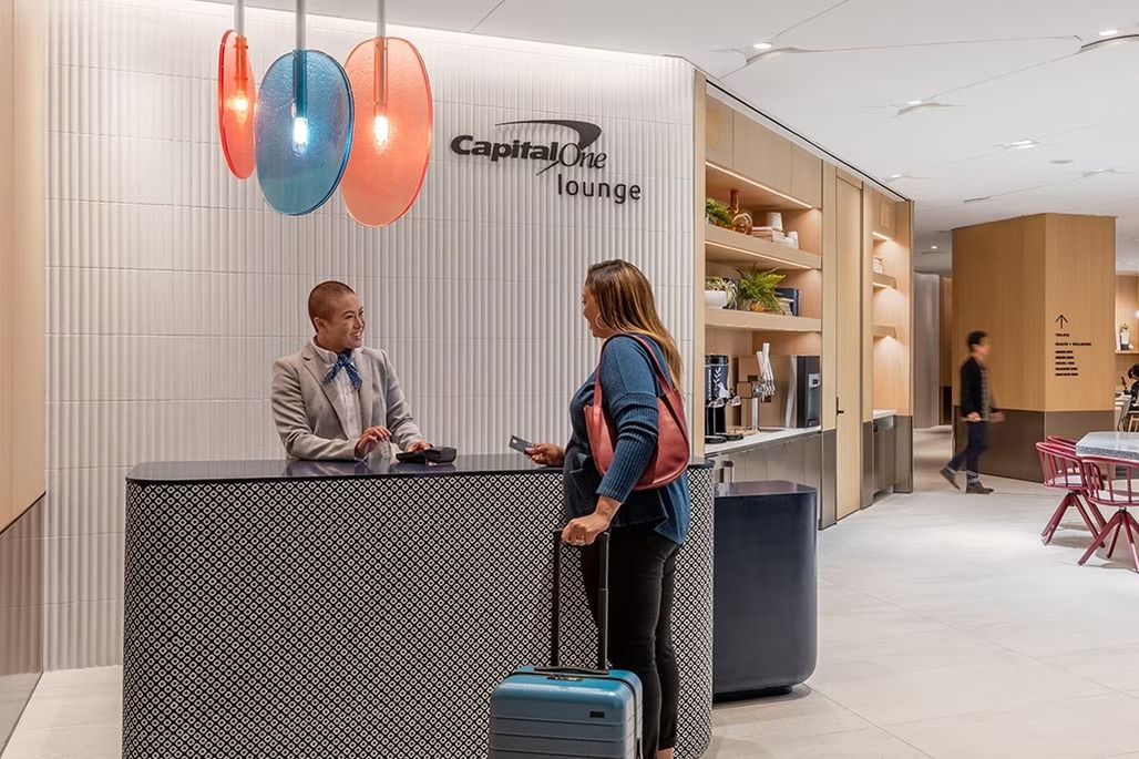 A passenger entering a Capital One Lounge.