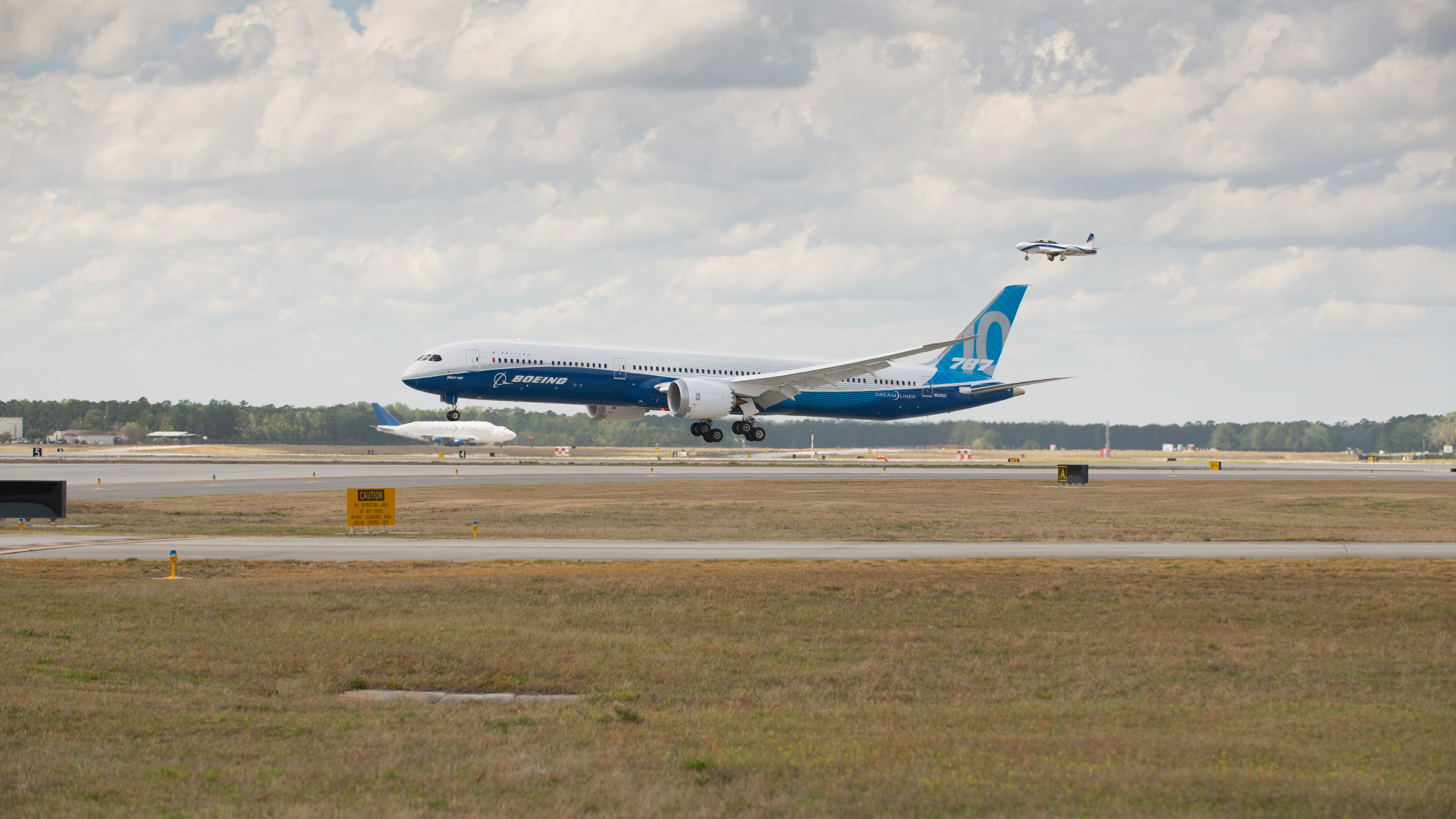 A Boeing 787-10 about to land on a runway.