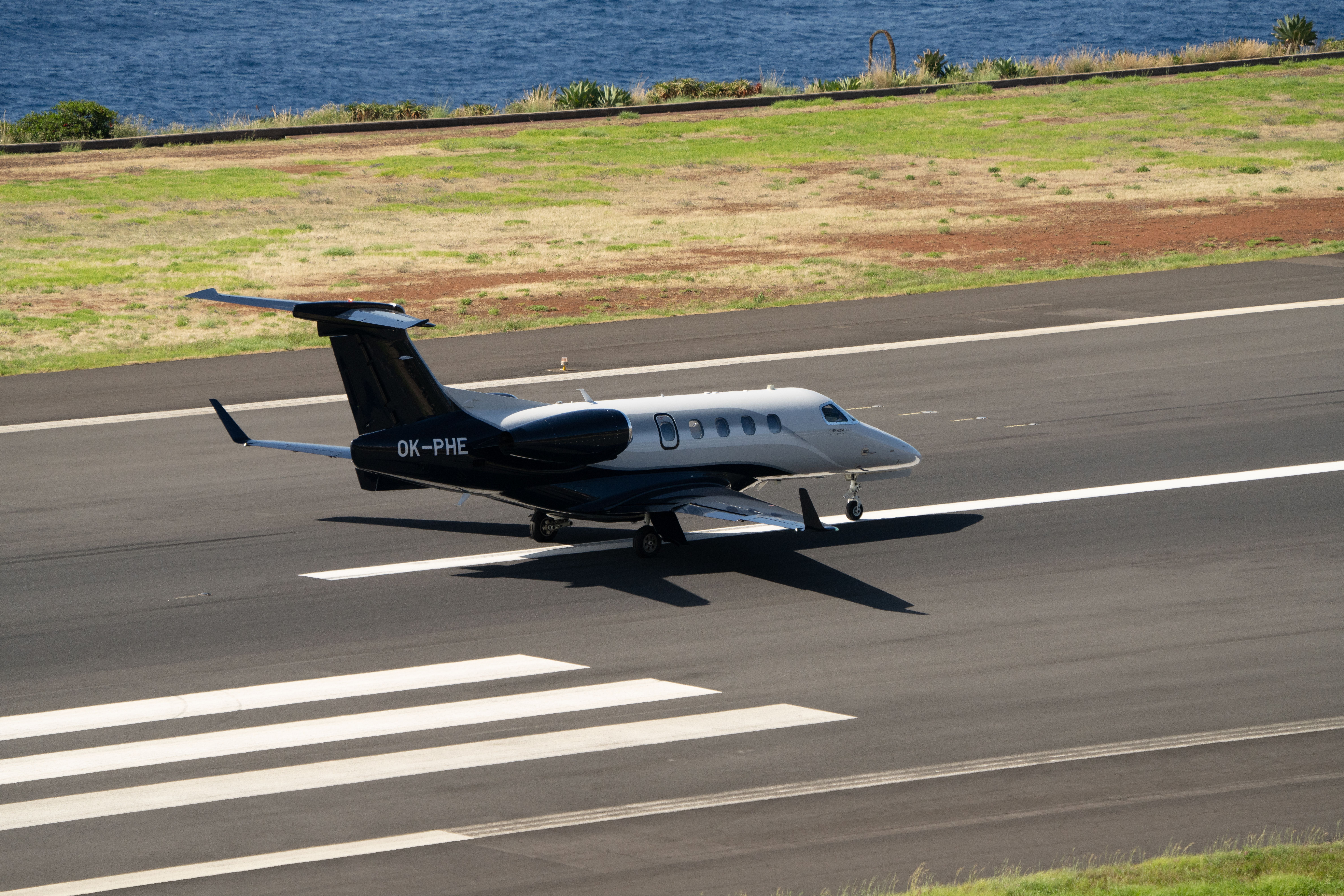 An Embraer Phenom 300E On a runway.