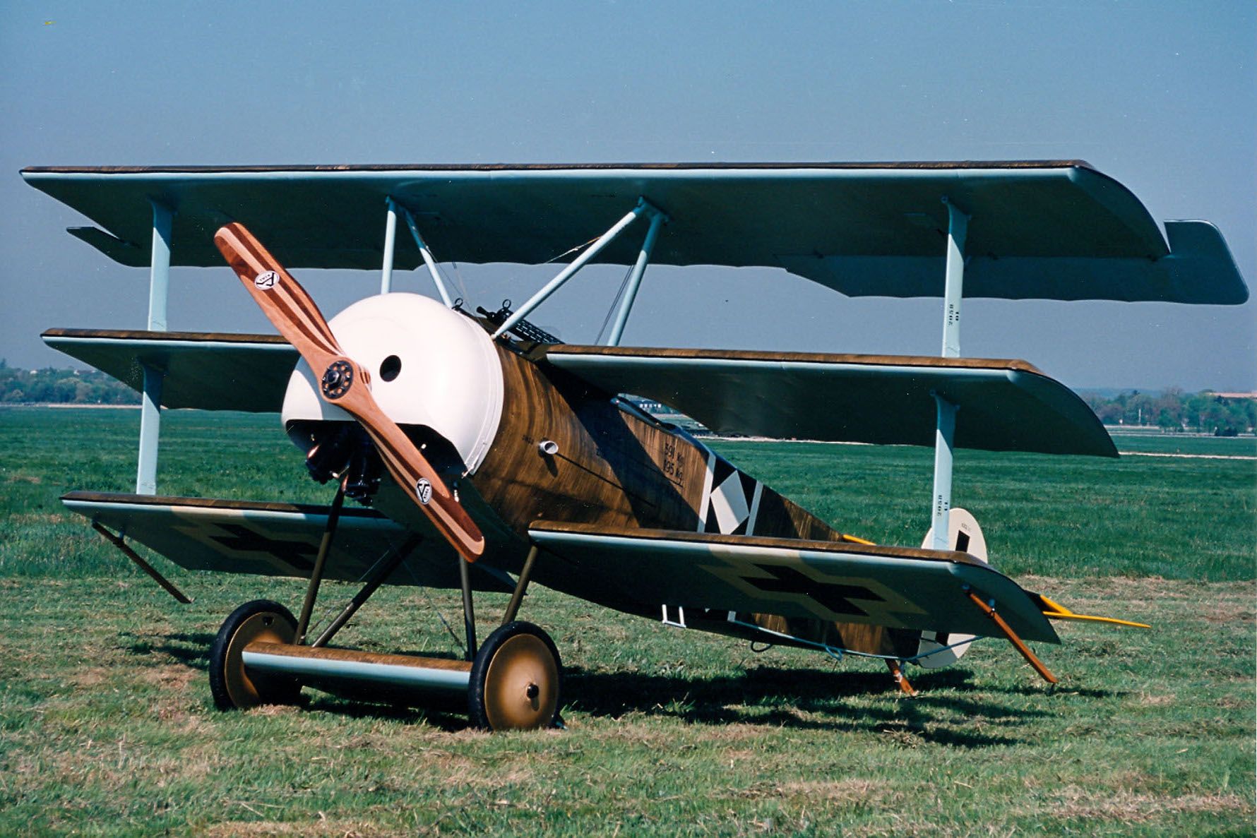 A Fokker Dr.1 sitting in a field.