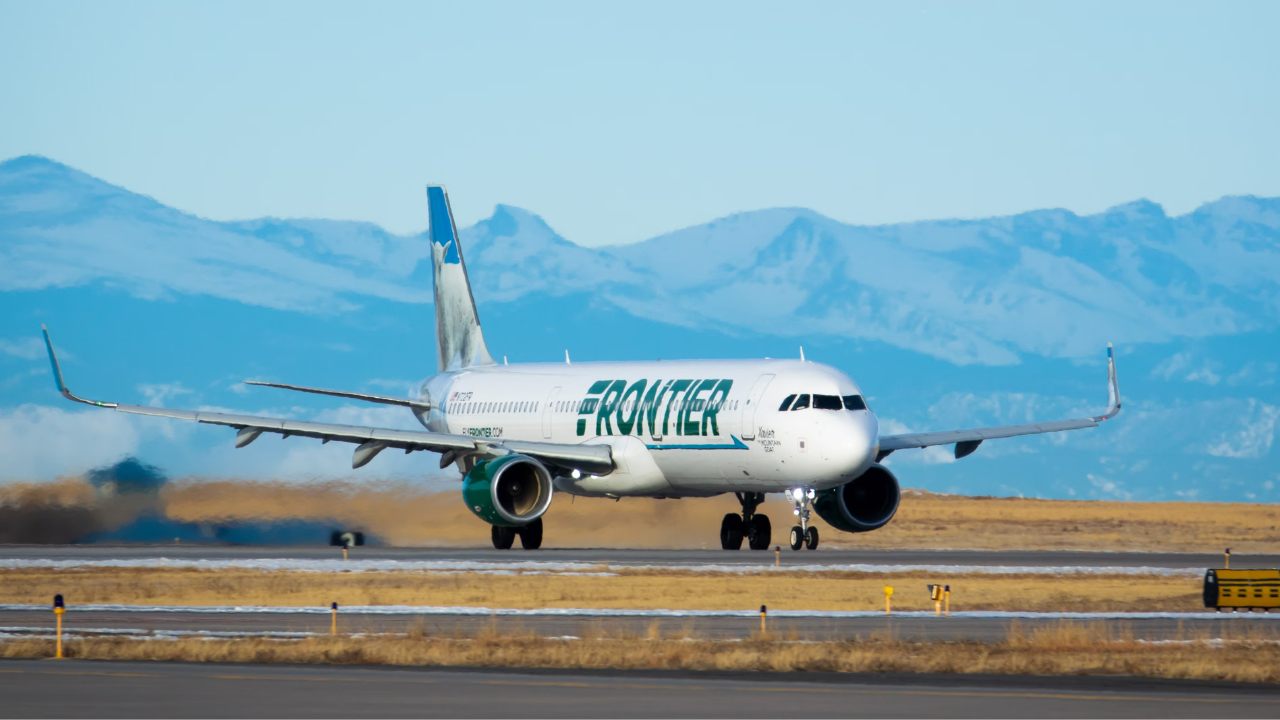 A Frontier Airlines Aircraft on an airport apron.