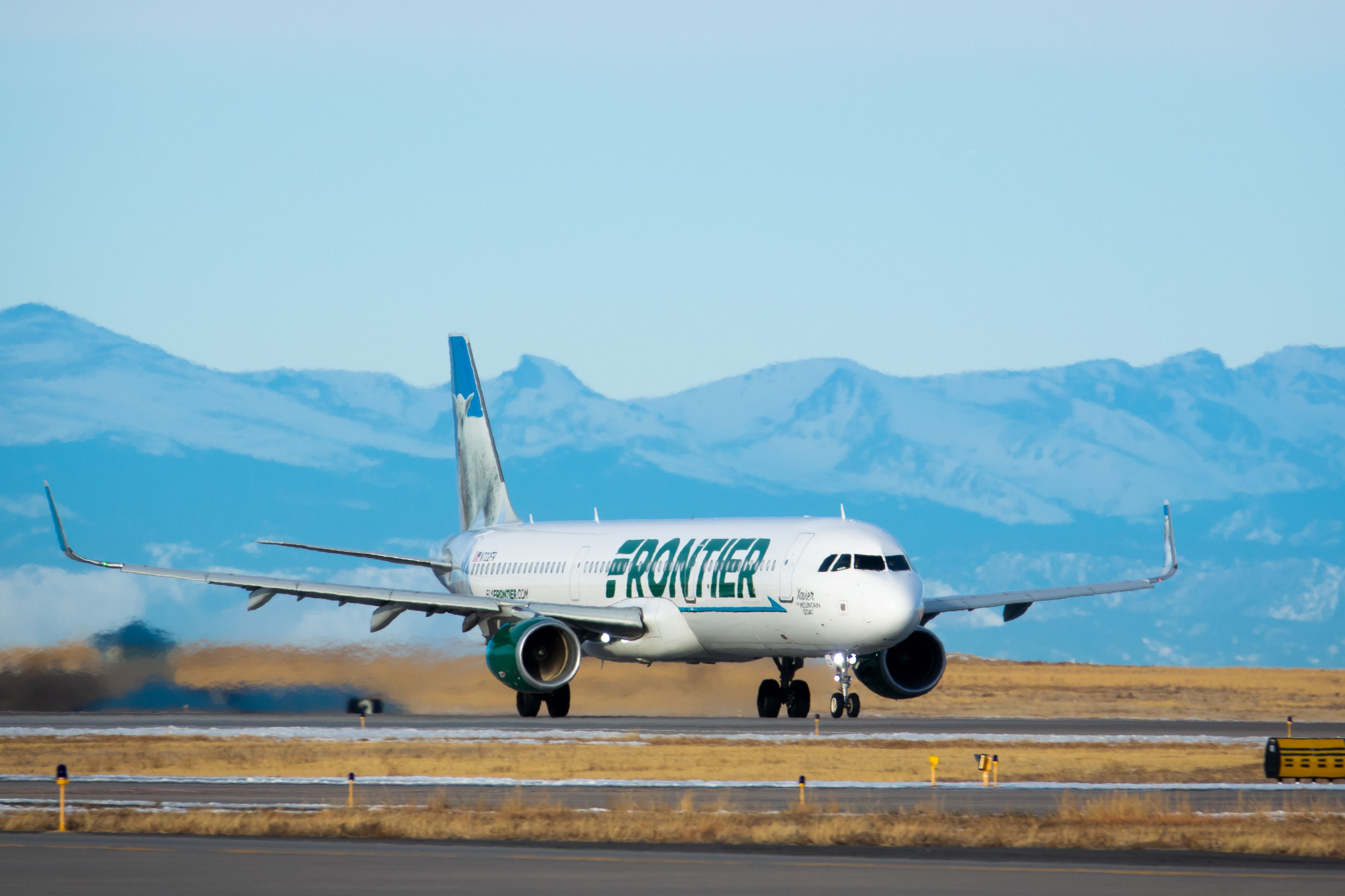 A Frontier Airlines Aircraft on an airport apron.