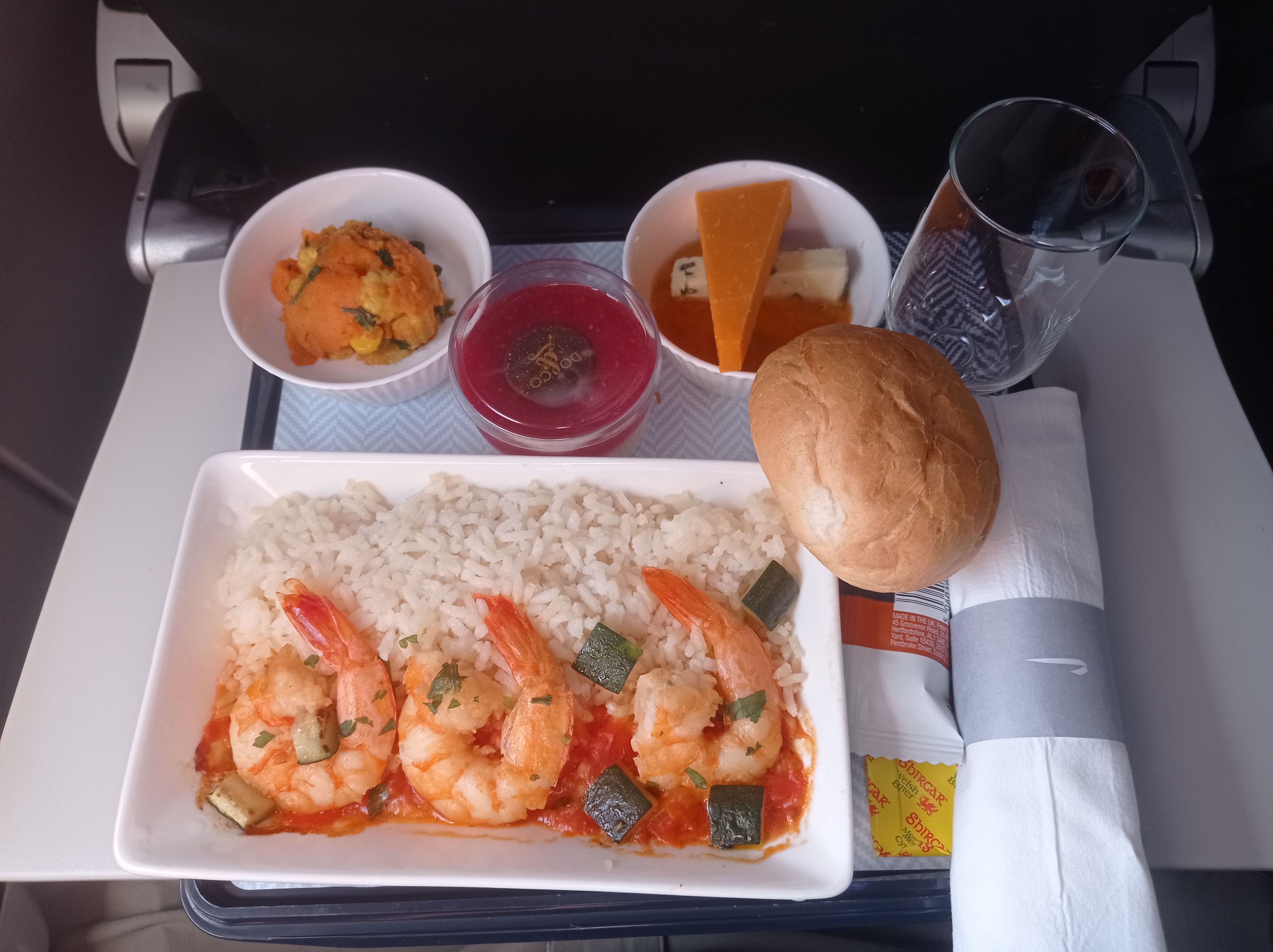 A Meal with shrimp and bread served in British Airways Club Europe class.