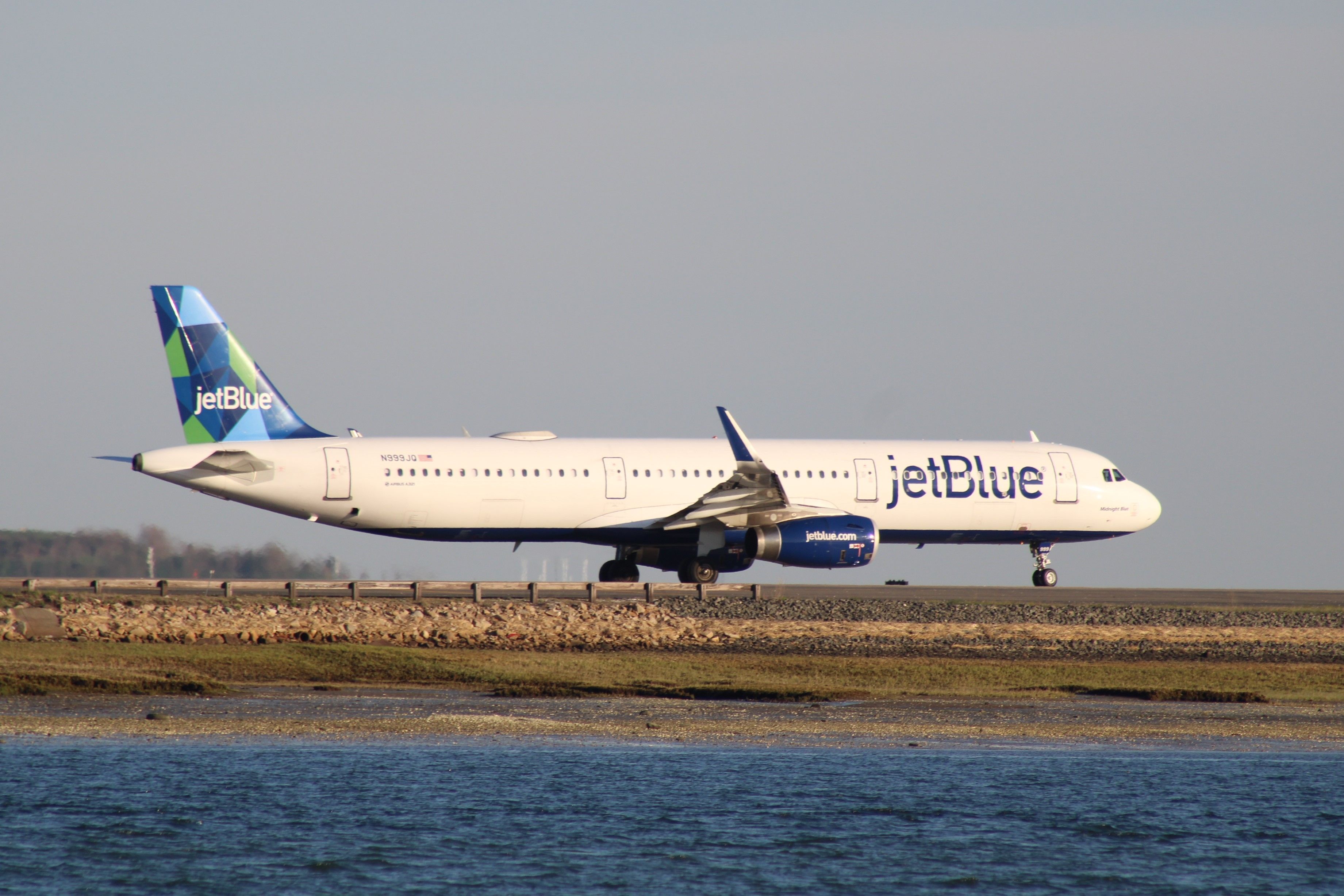 JetBlue Airbus A321 taxiing at Boston Logan International Airport BOS shutterstock_2153306735