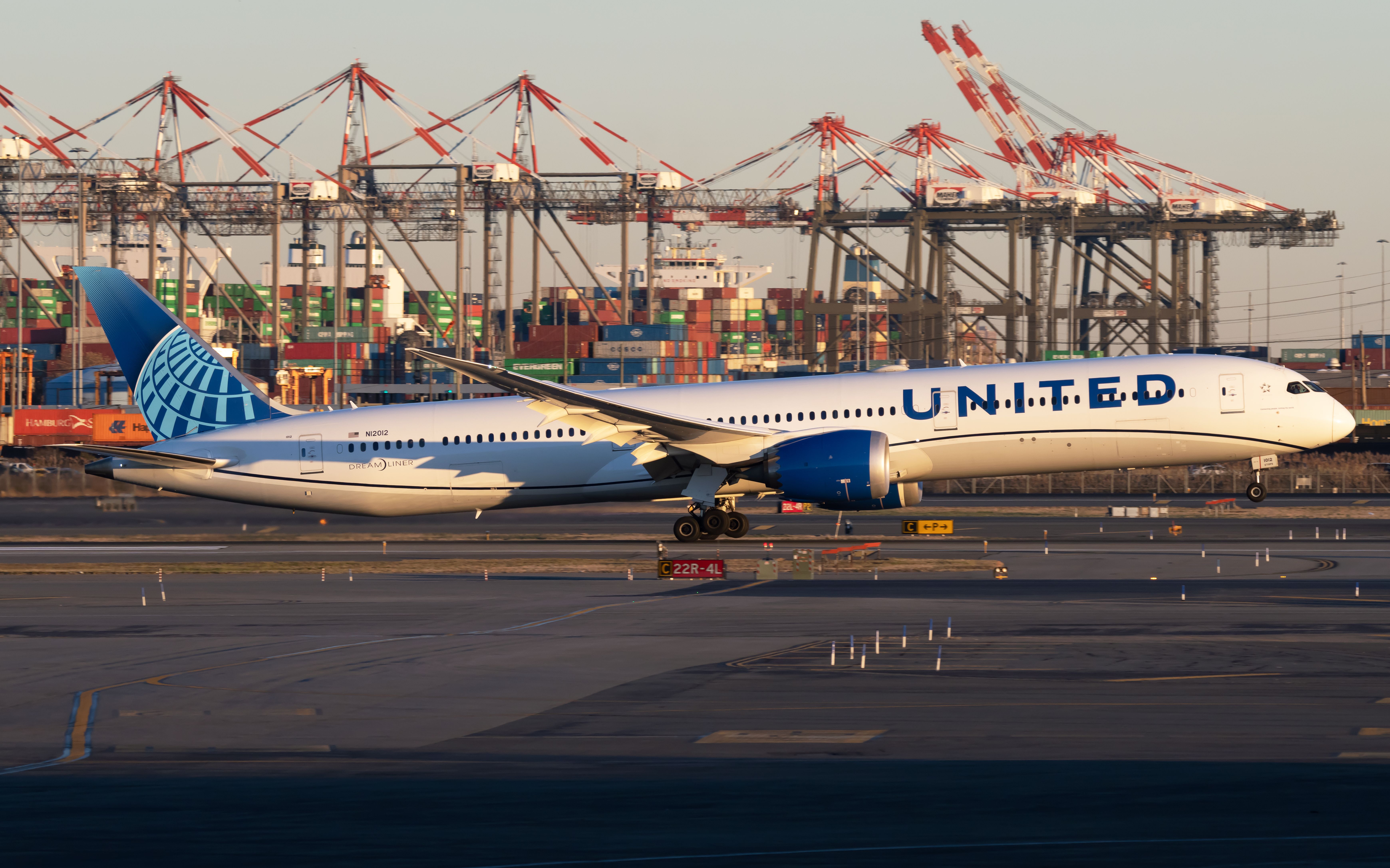 A United Airlines Boeing 787-10 Dreamliner just above the runway at Newark Liberty Airport.