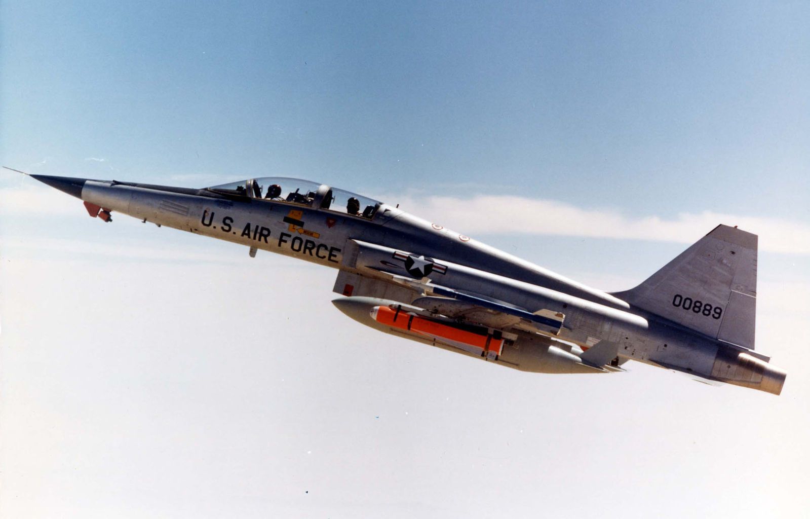 A Northrop F-5 flying above the clouds.