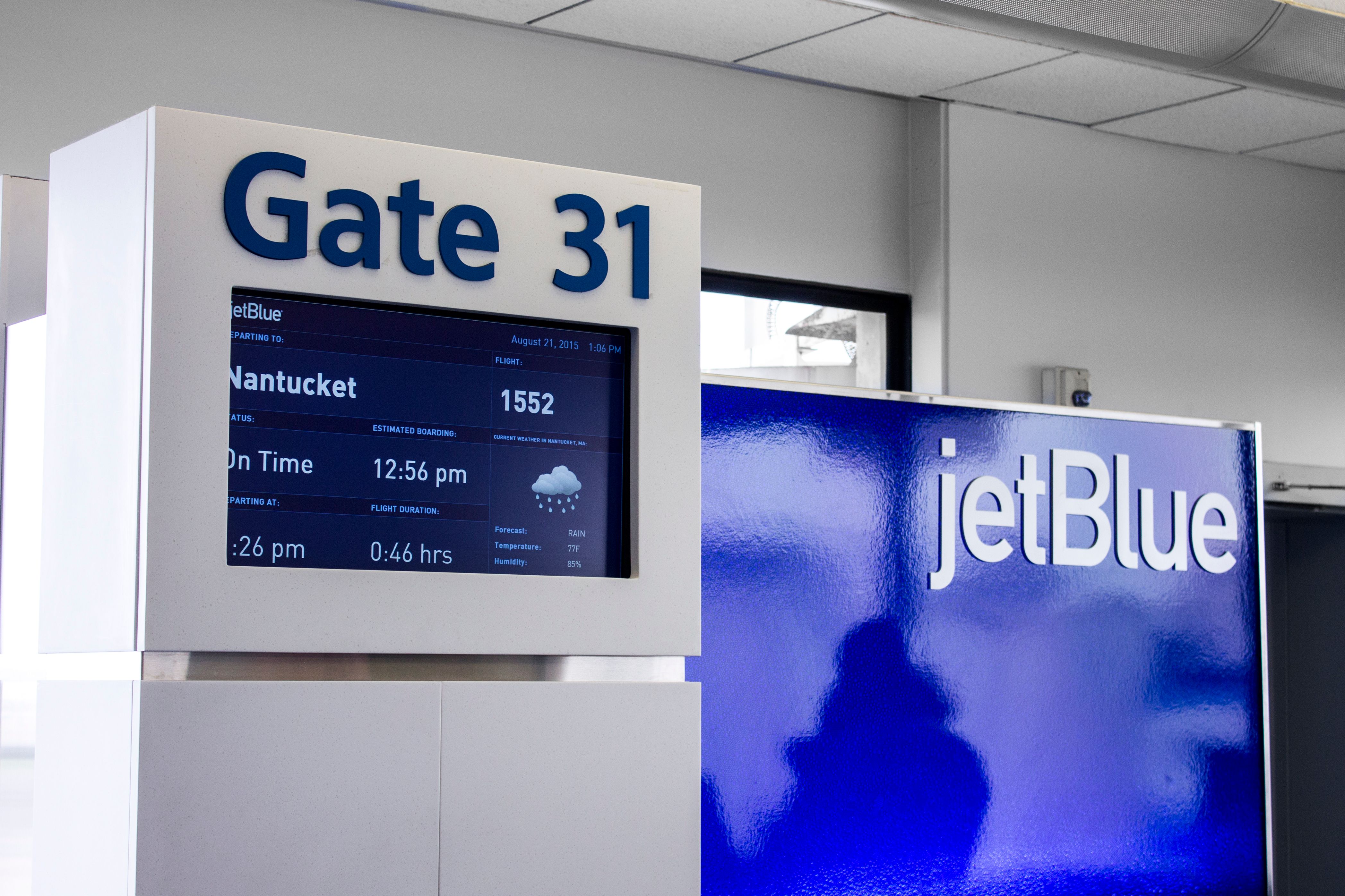 A photo of a screen at an airport gate used by Jetblue for a flight to Nantucket.