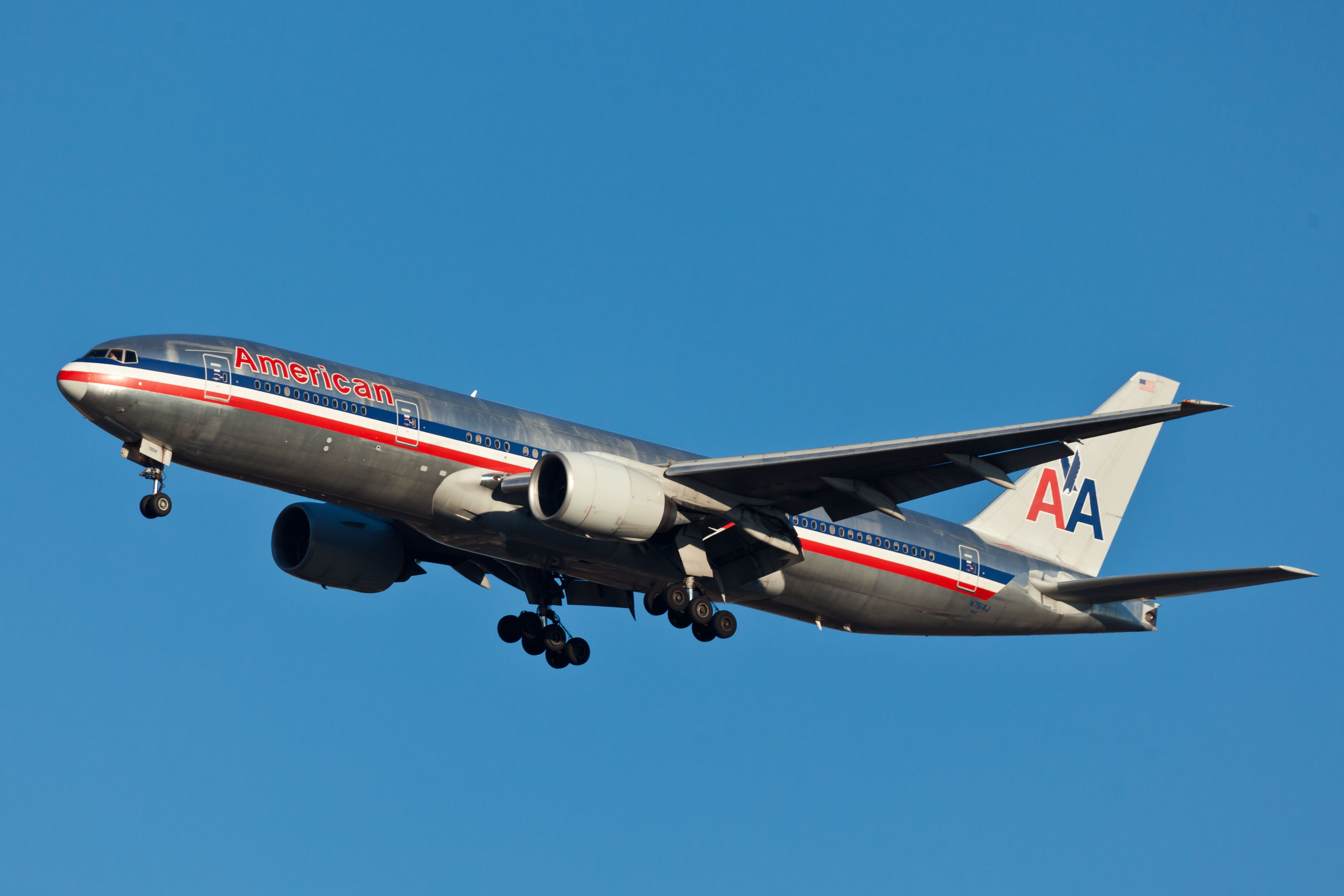 An American Airlines Boeing 777 flying in the sky.