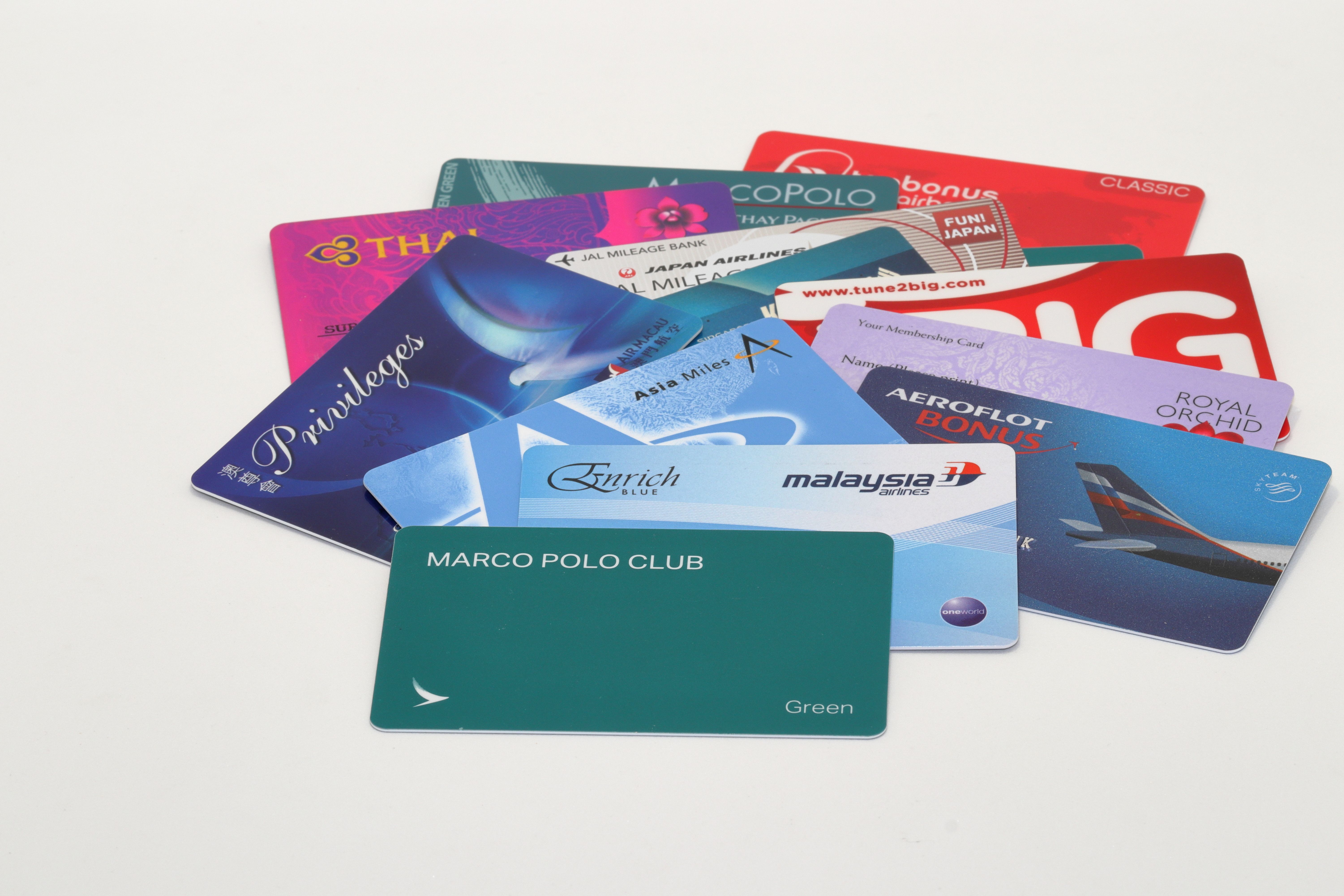 Several Frequent Flyer miles cards in a pile.