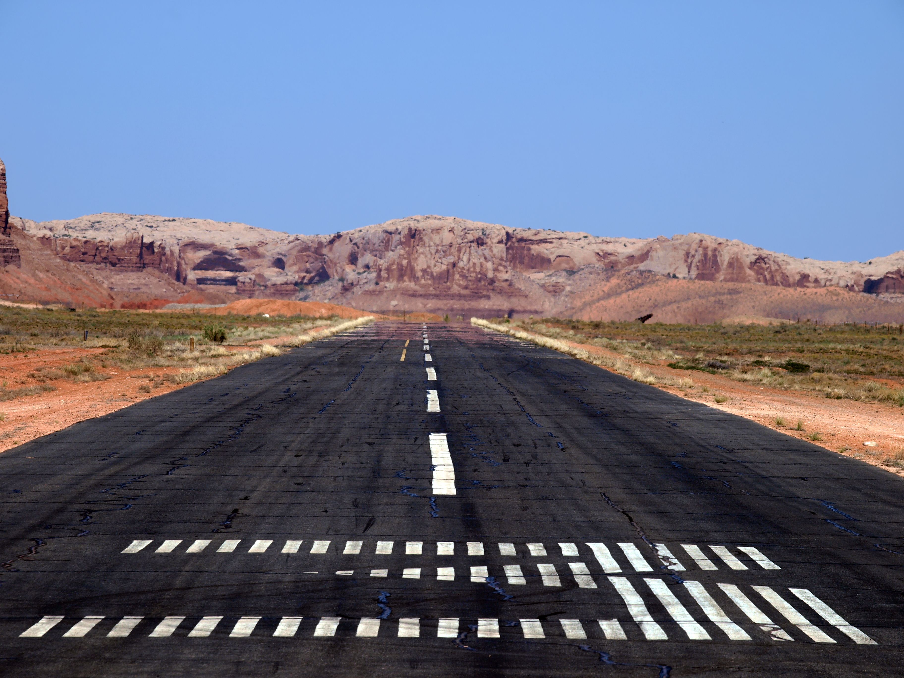 Heat visibly rising off a runway in a desert.