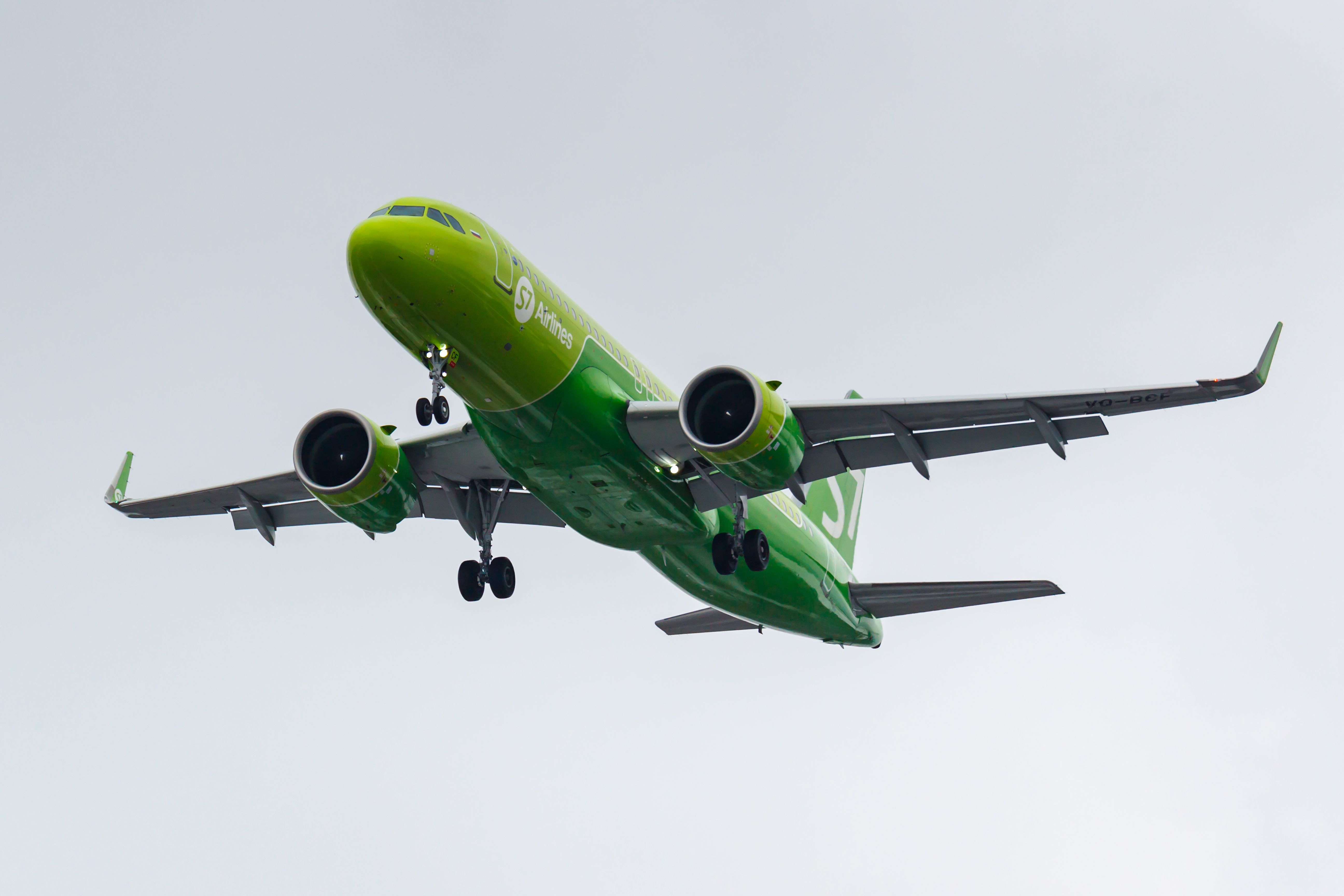 An S7 Airlines Airbus A320neo flying in the sky.