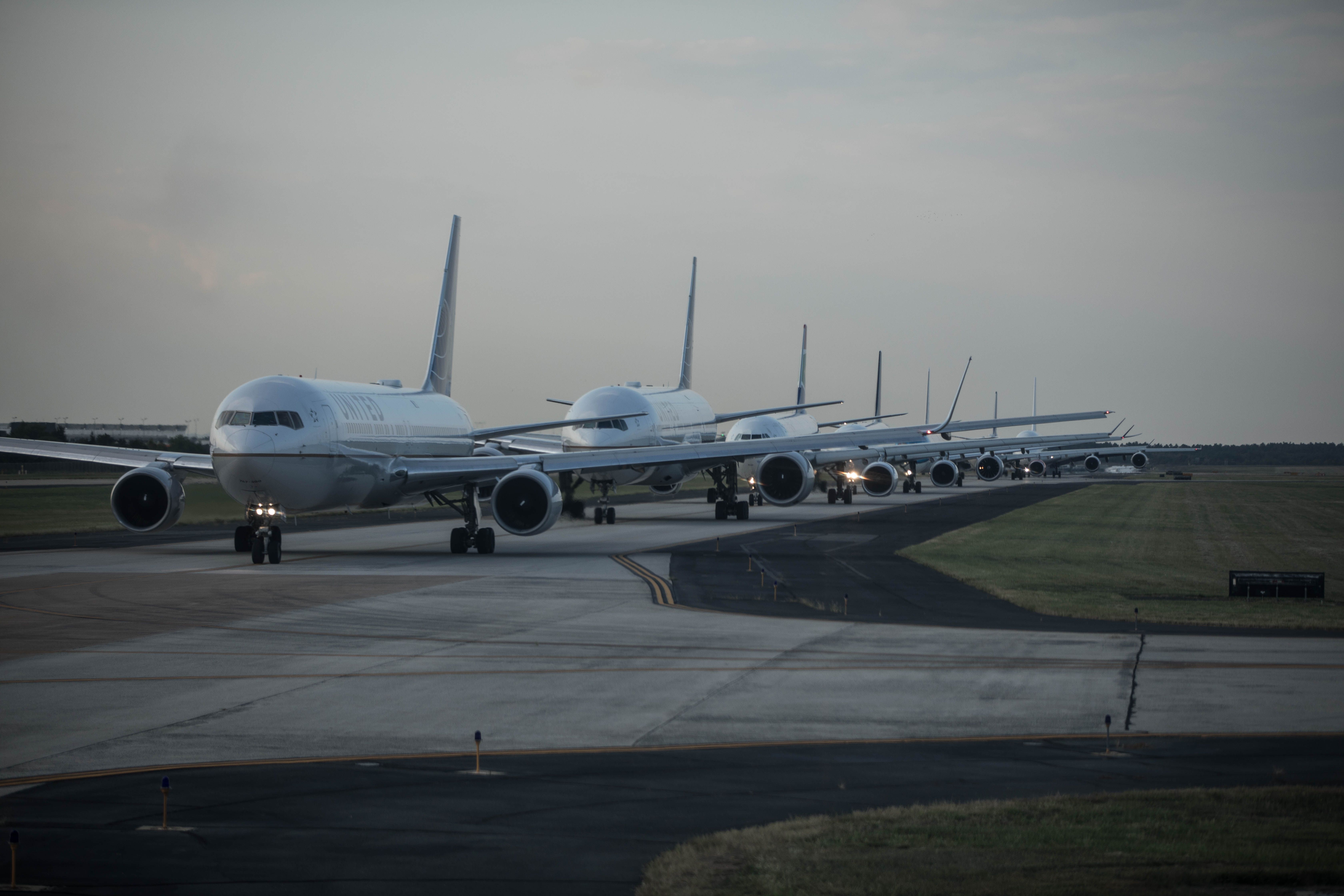 A number of planes, including United Airlines planes, lining up for the runway on Washington Dulles International Airport (IAD).