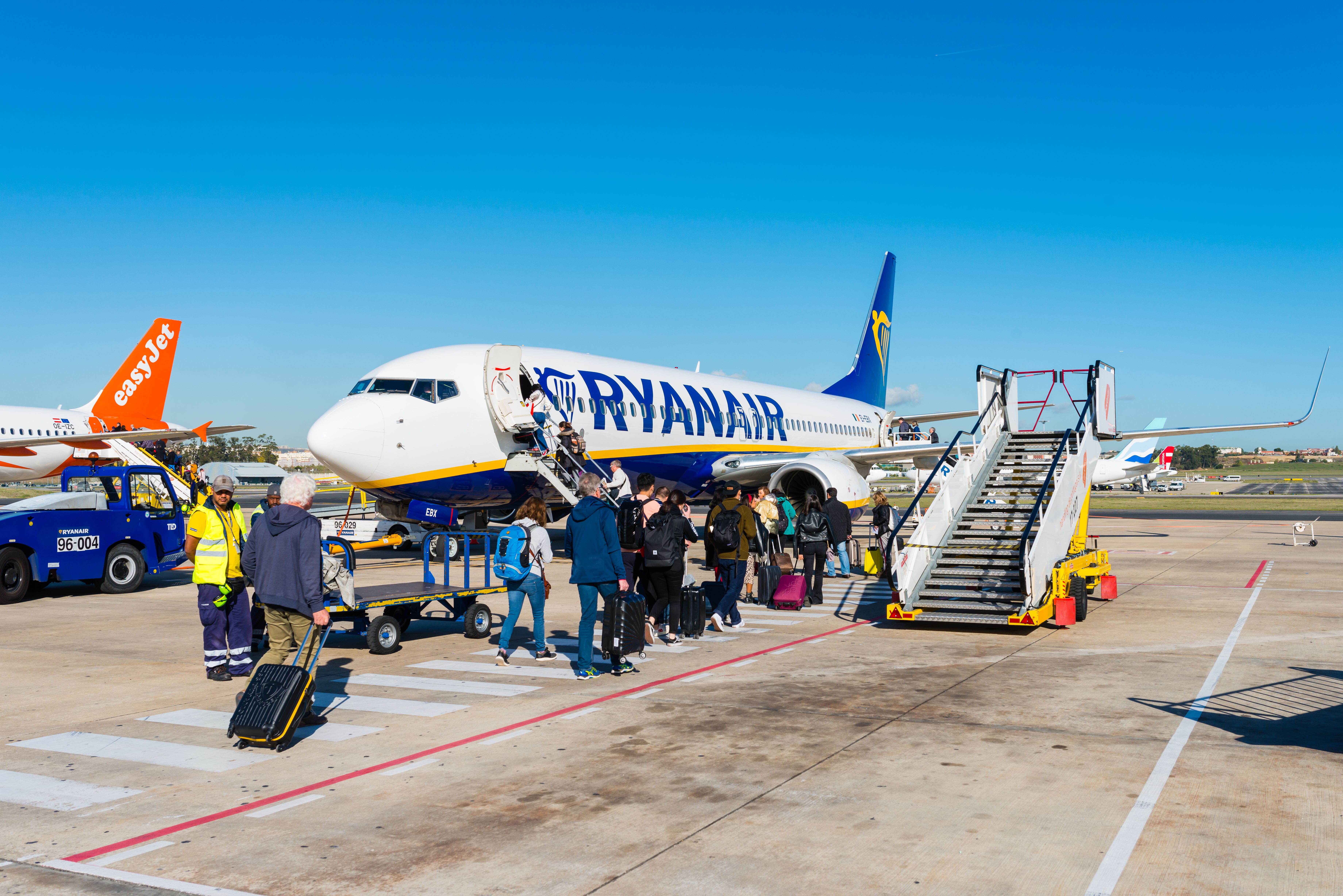 Passengers boarding A Ryanair Boeing 737 parked on the apron in Lisbon.
