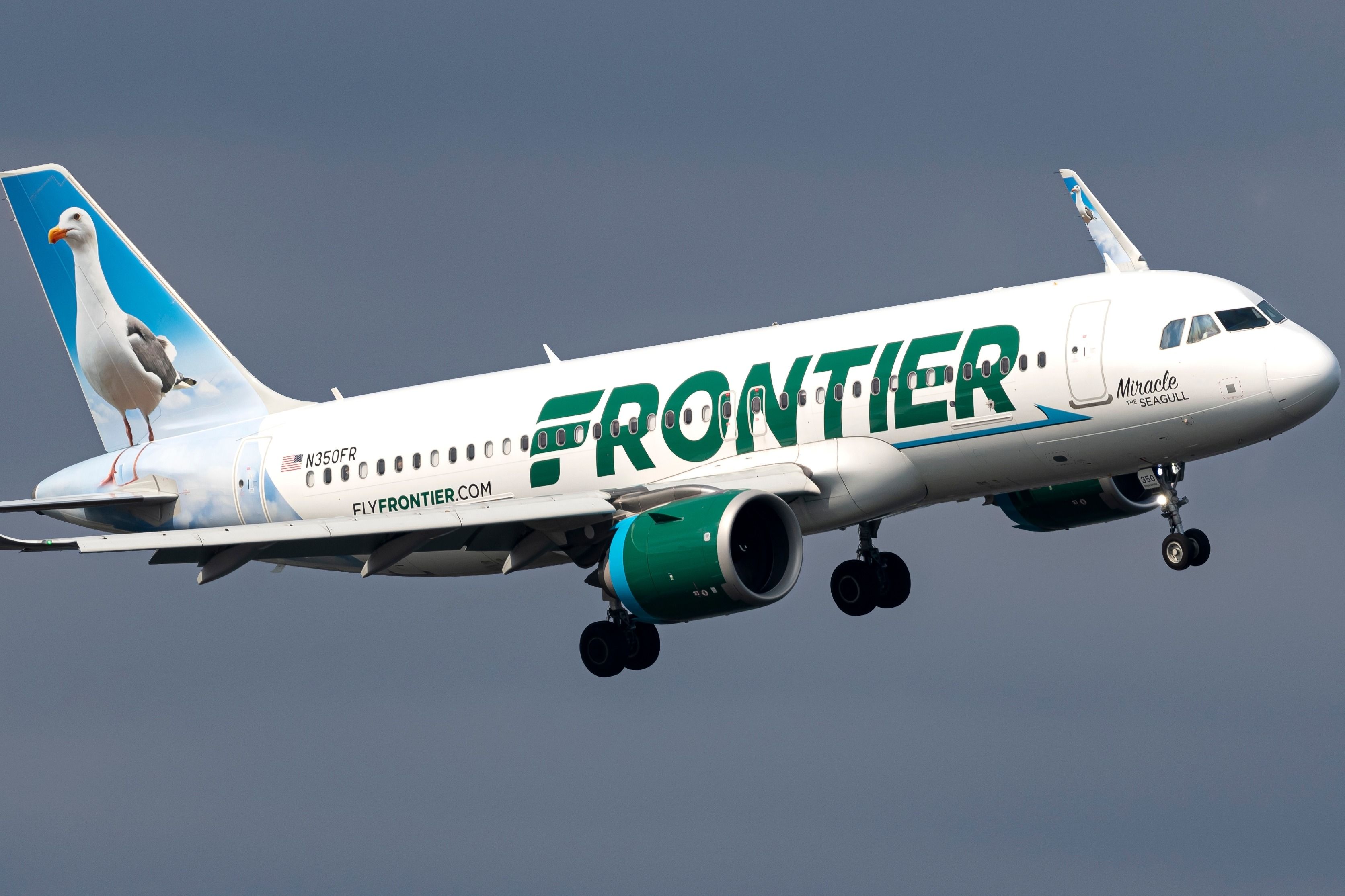 A Frontier Airlines Airbus A320 flying in the sky.