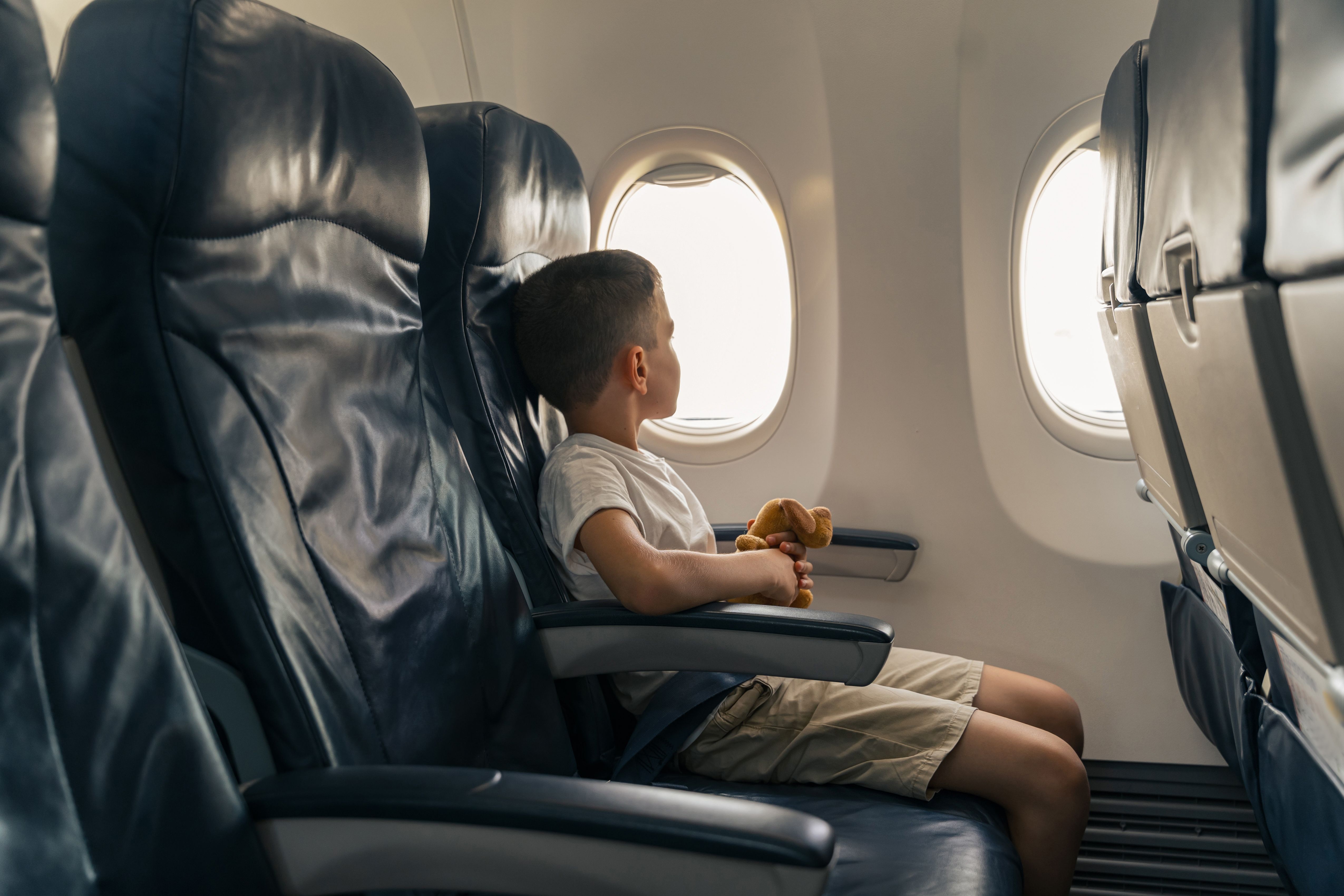An Unaccompanied minor sitting in an aircaft.