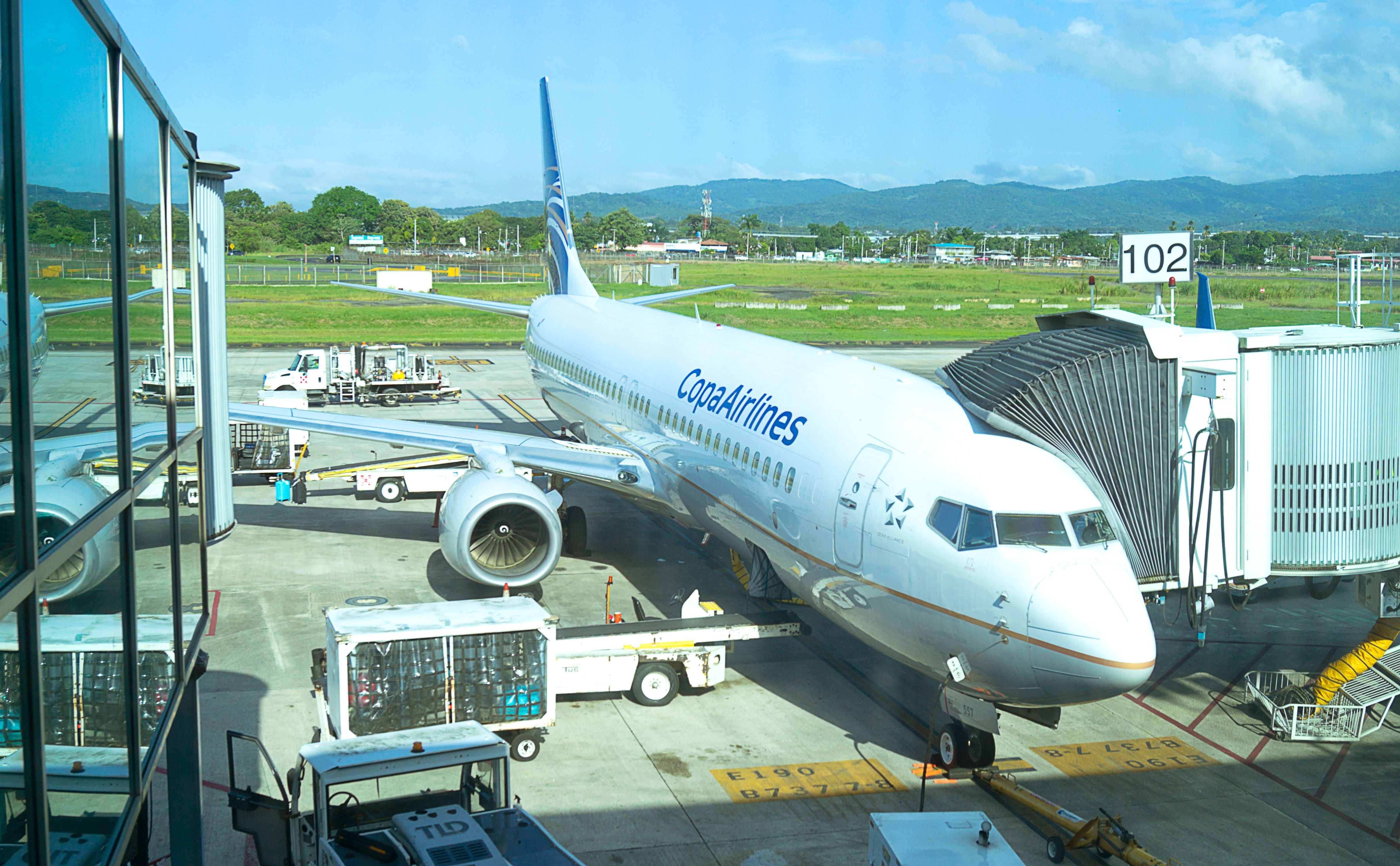 A Copa Airlines aircraft on an airport apron parked at a gate.