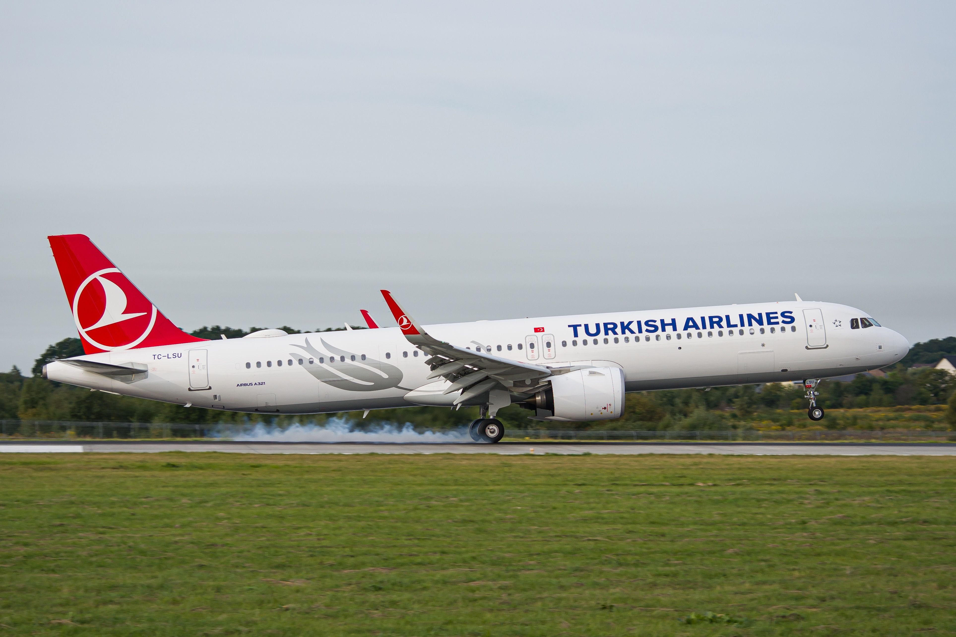 A Turkish Airlines A321 as it lands on a runway.